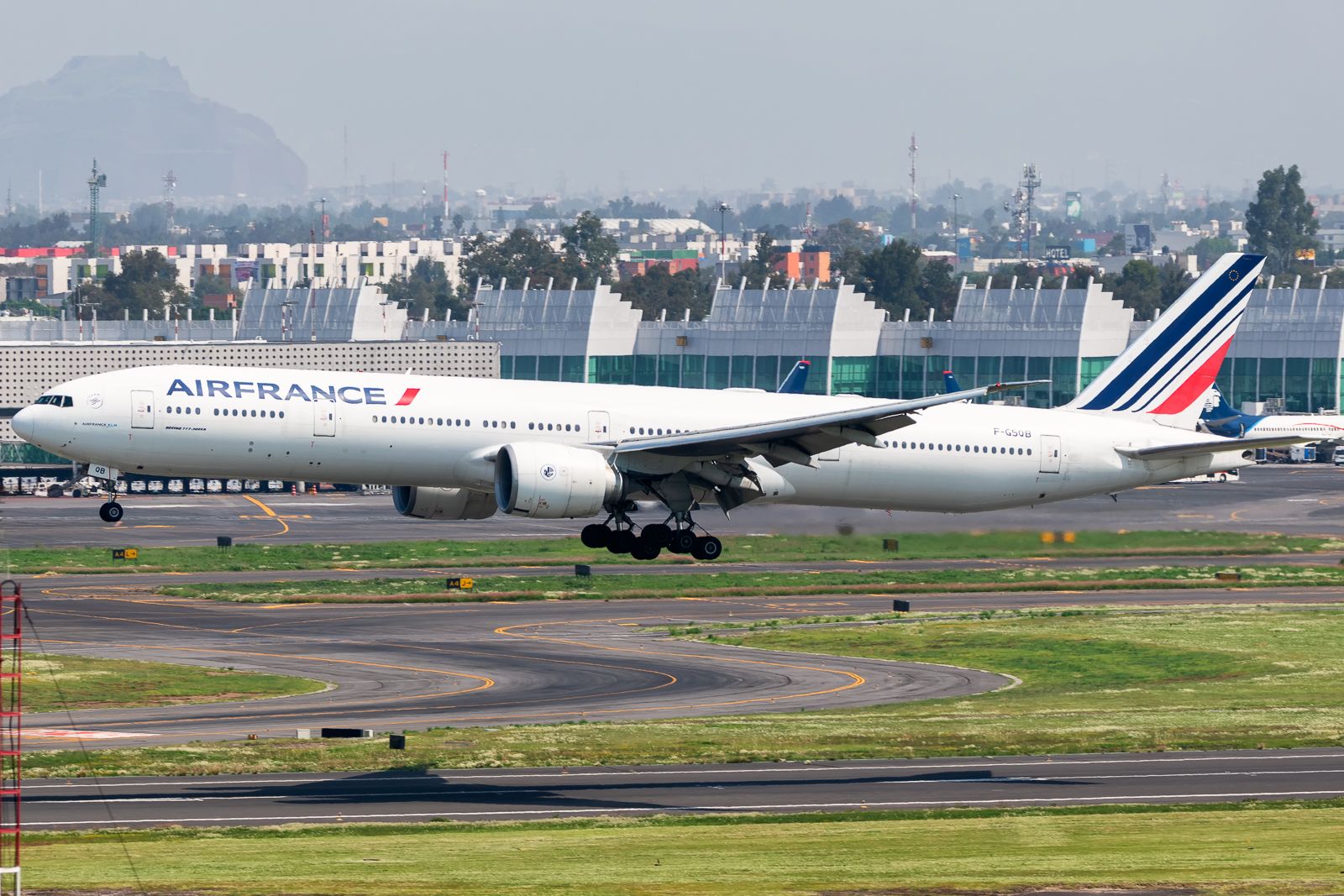An Air France Boeing 777-300ER about to land at an airport.