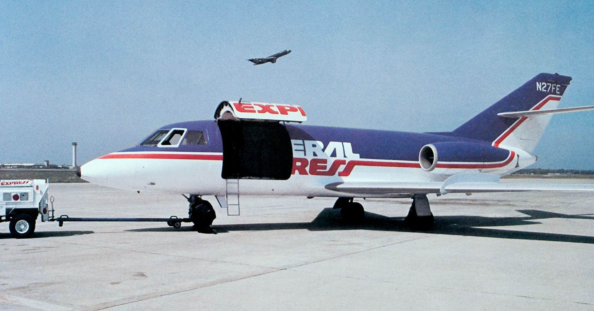 A FedEx Dassault Falcon aircraft with its cargo door open. 
