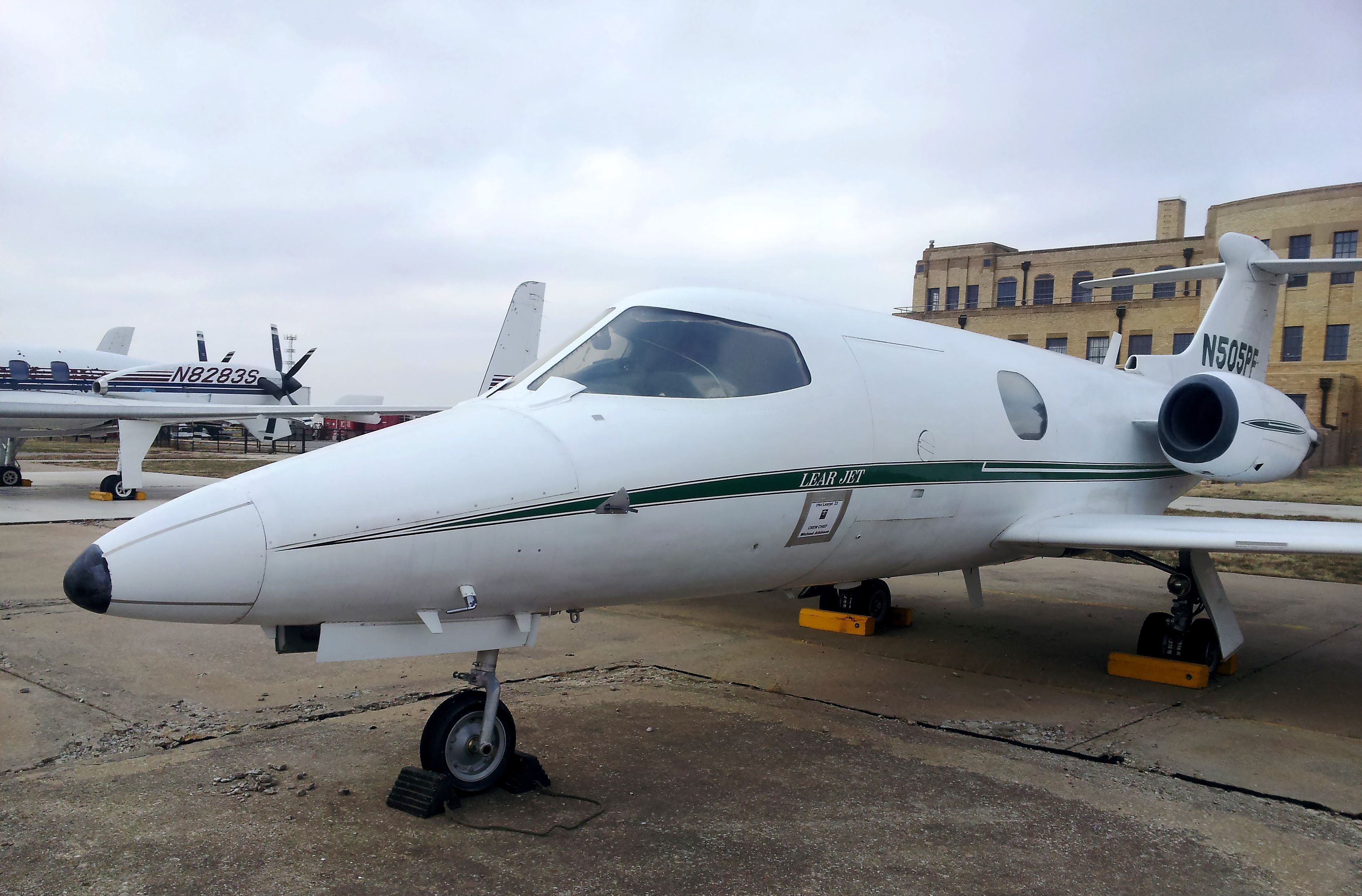 A Learjet 23 parked at an airport.