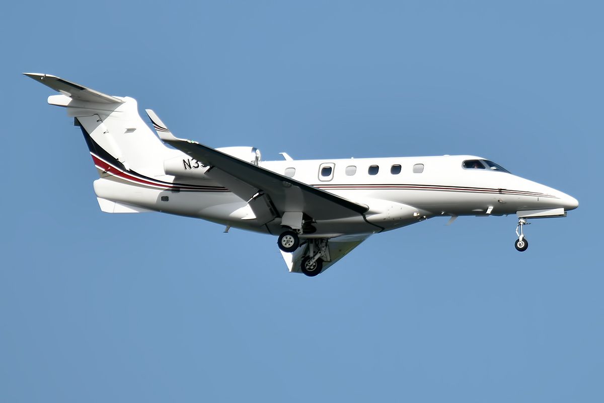 A Netjets Embraer aircraft flying in the sky.