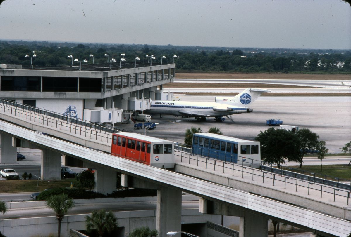 The Tampa Airport Original People Movers rolling along the tracks.