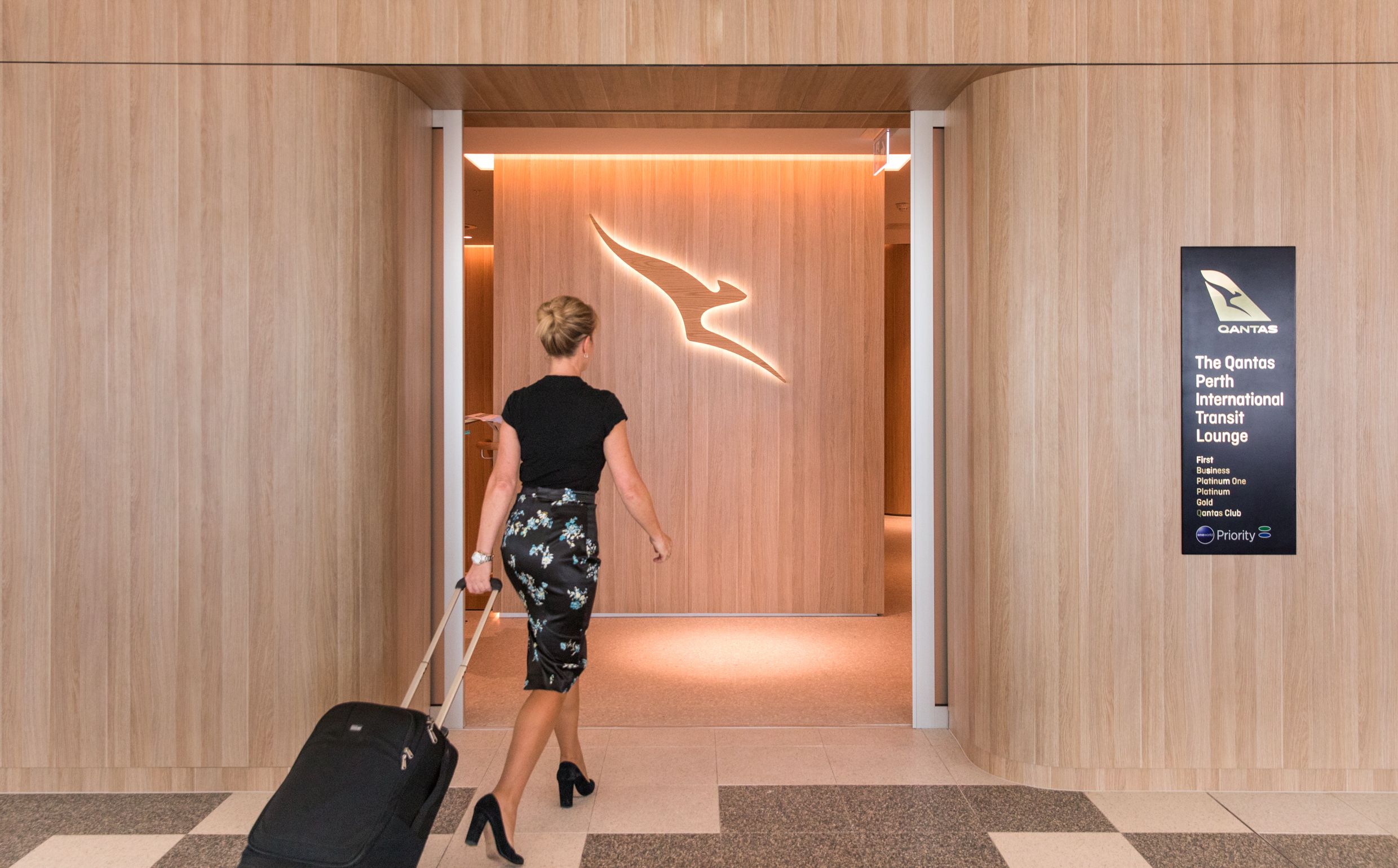 A qantas passenger going into a lounge
