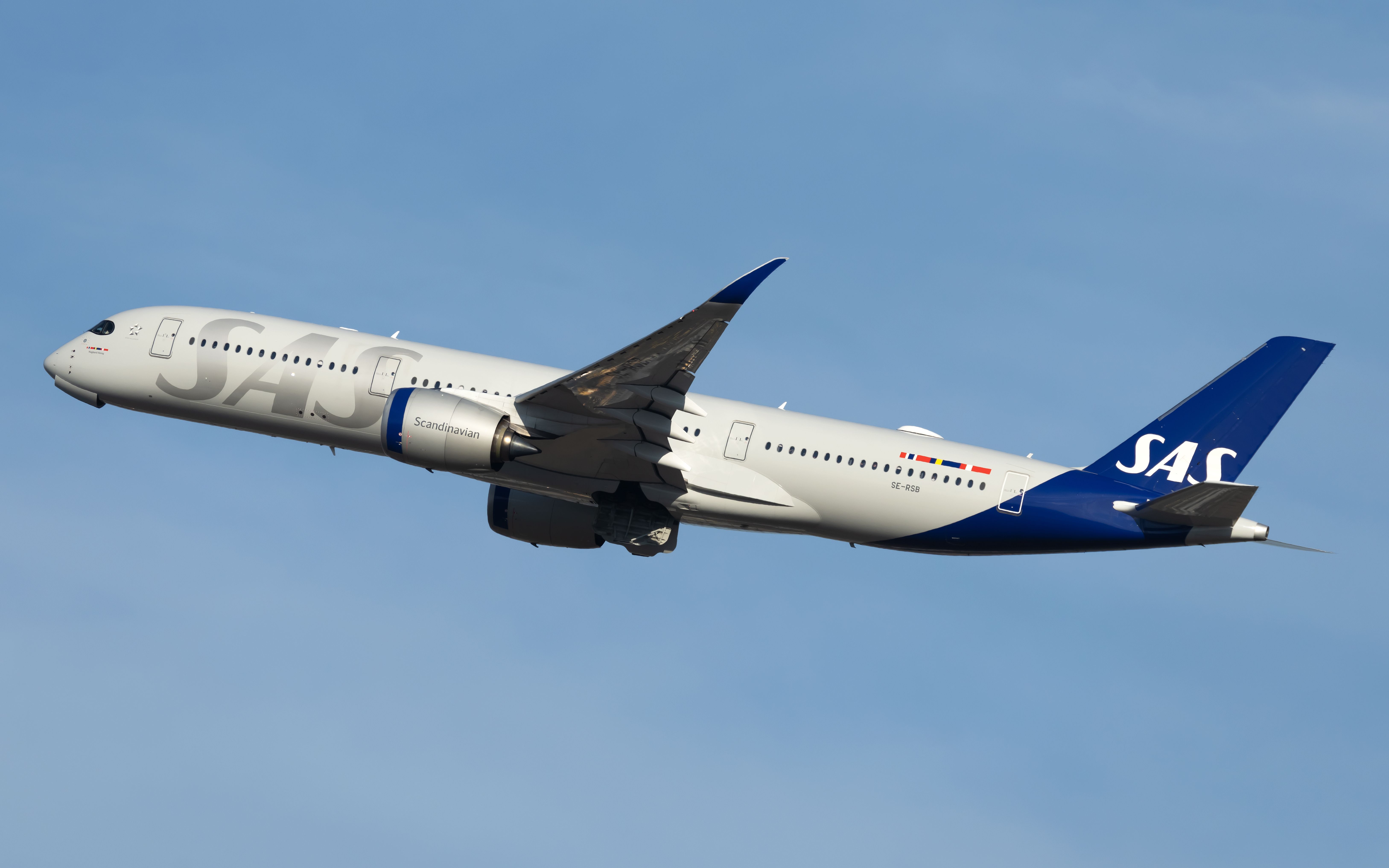 An SAS Airbus A350-941 flying in the sky.