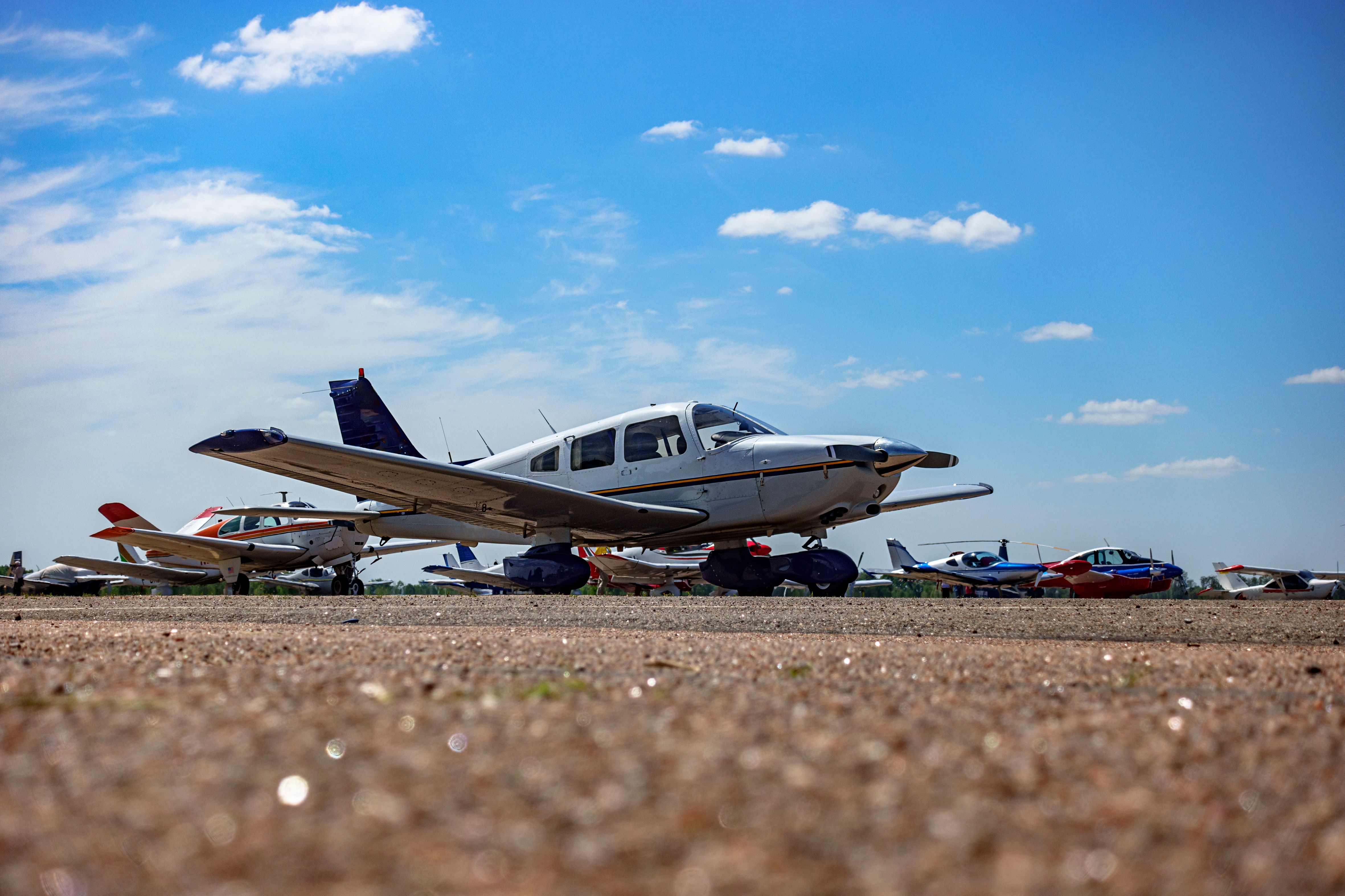 A few general aviation aircraft parked at a field. 