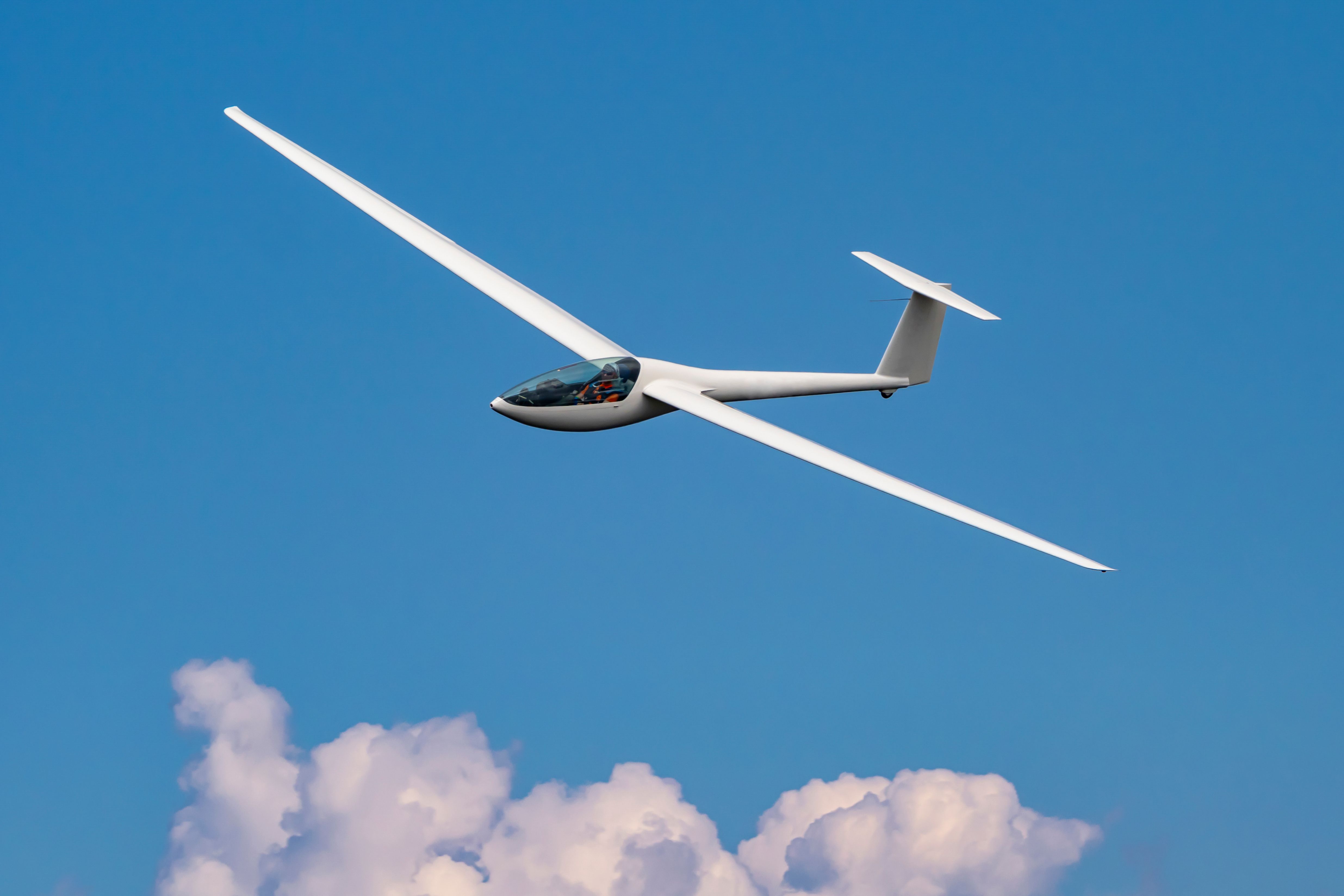 A glider flying at cloud level.