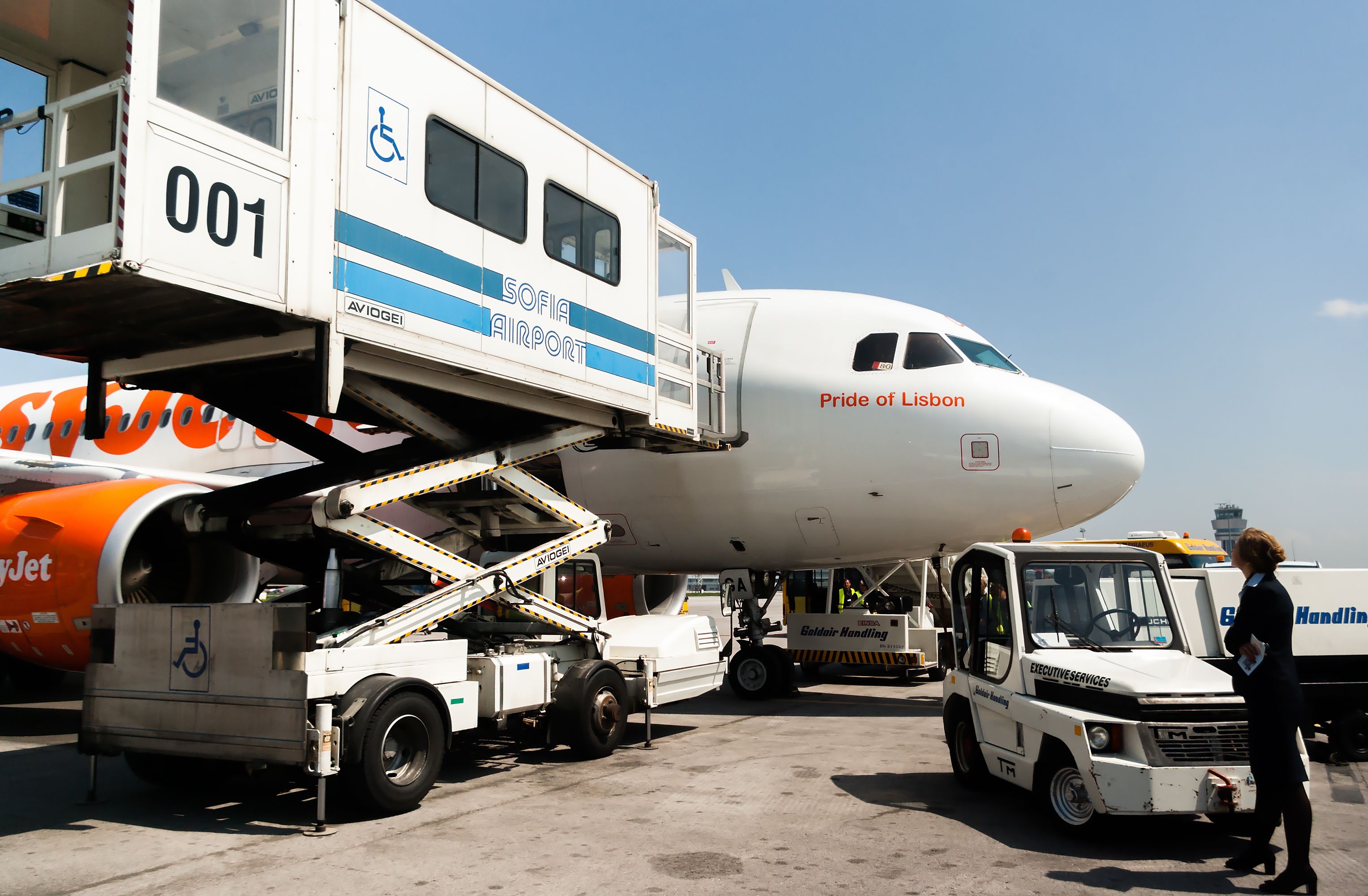 Airport passenger mobility assistance vehicle, also known as PRM, is seen in action next to an easyJet Airbus A320 at Sofia airport, Sofia, Bulgaria, April 22, 2014.