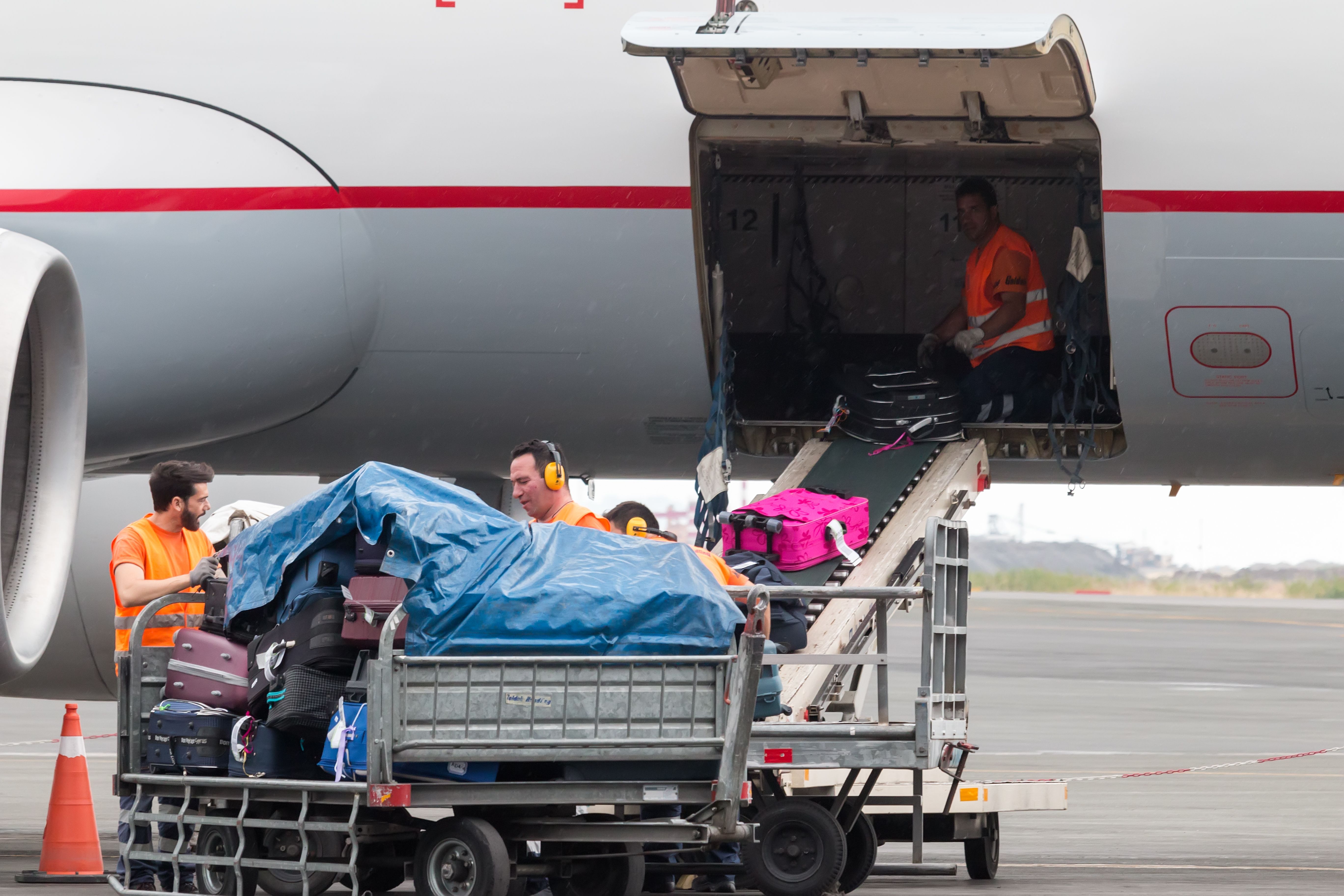 Baggage Handlers With Suitcases