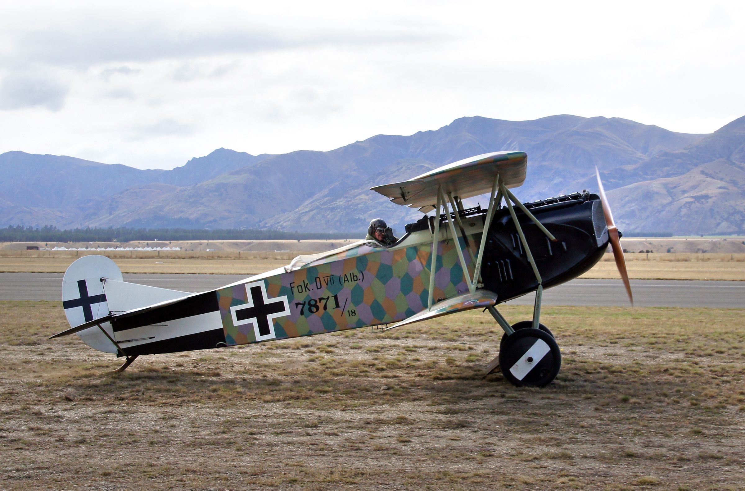 An old Fokker aircraft on display at an airfield.
