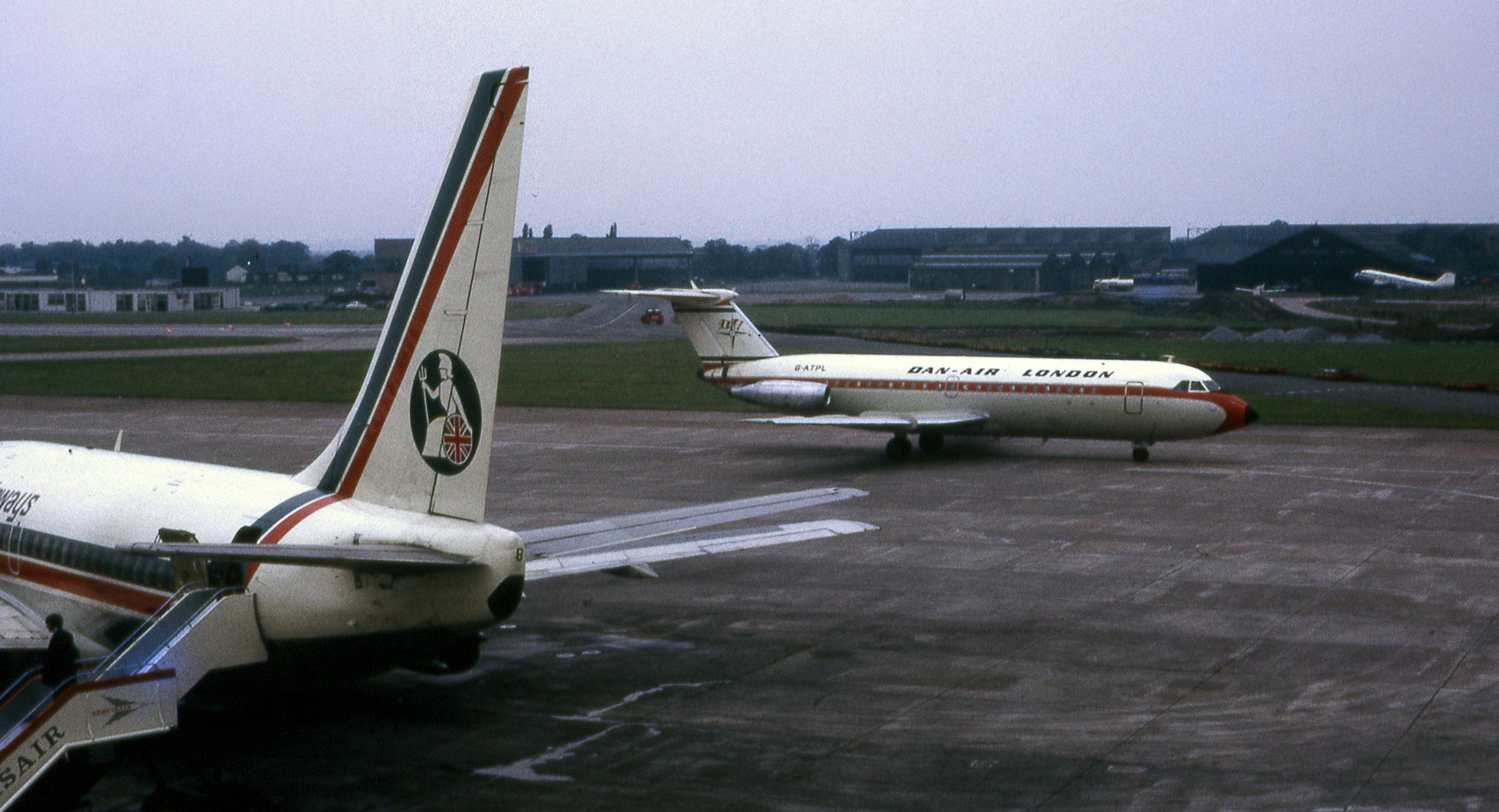 Multiple aircraft parked or taxiing at Manchester Airport circa 1972.