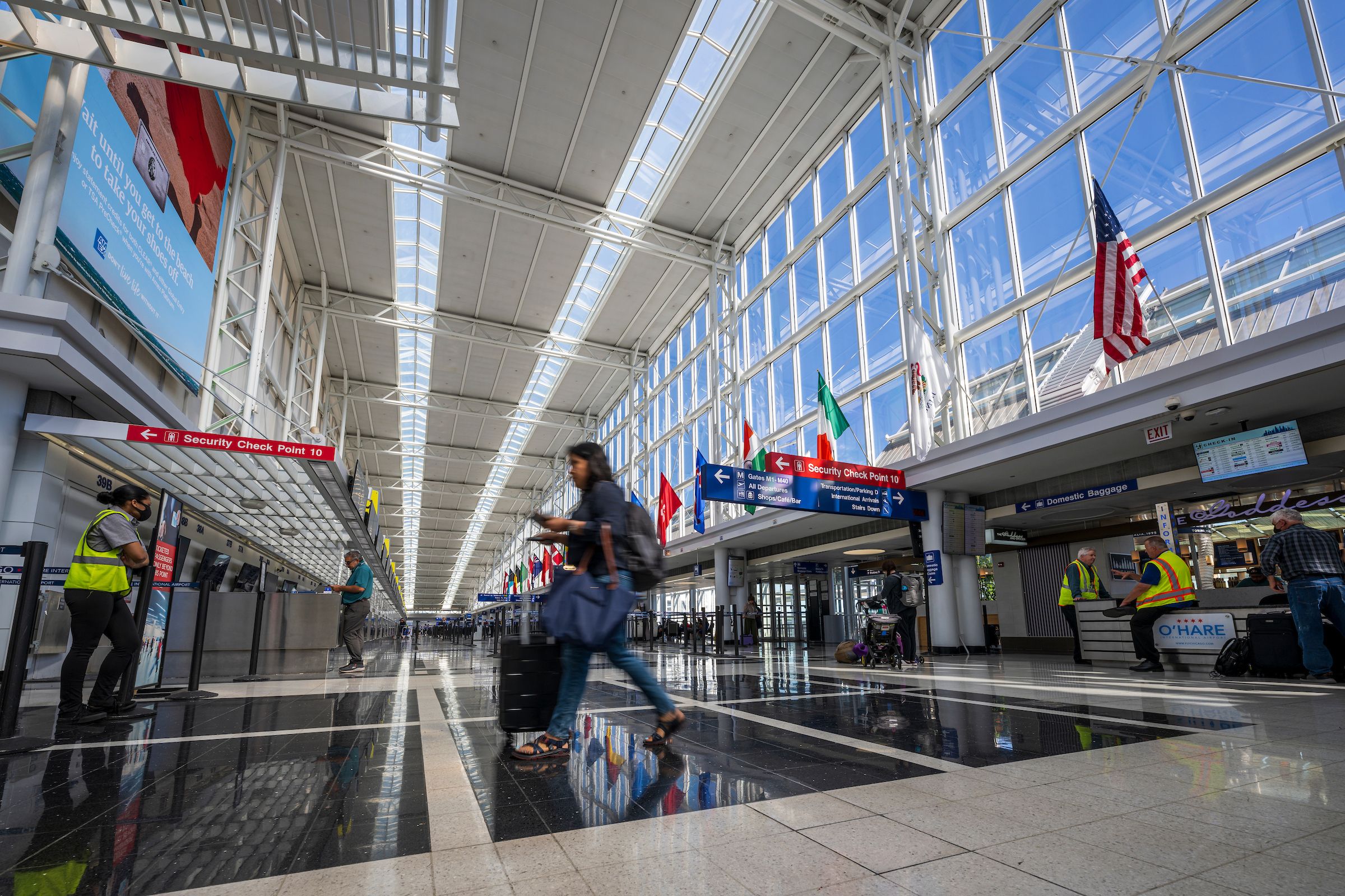 A traveler walking through Terminal 5 at Chicago O'Hare Airport.
