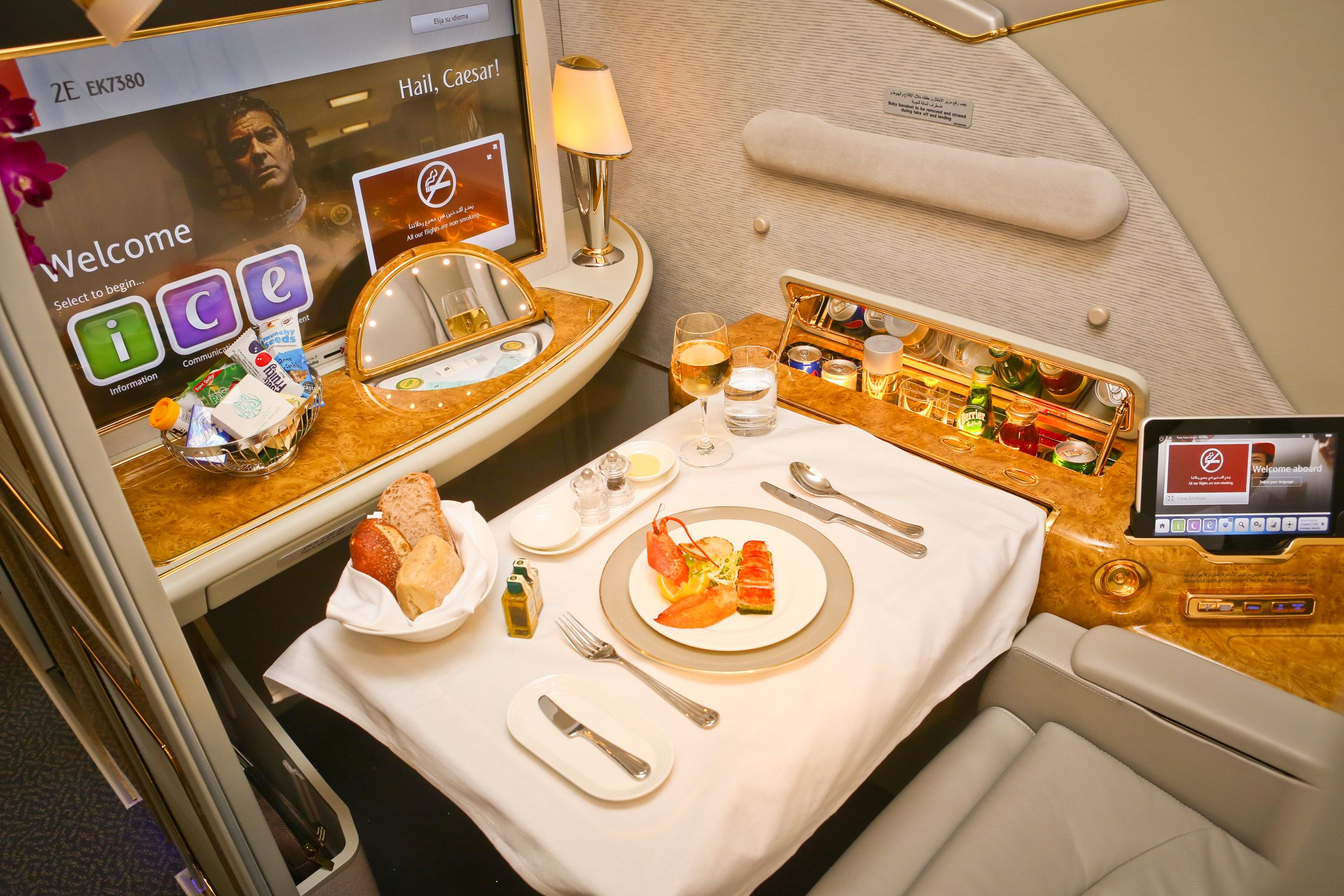 A picture of an Emirates first class suite, with meal set up on the table.