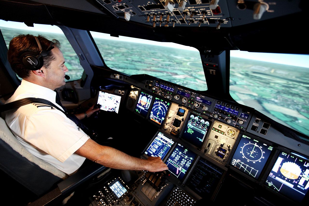 A British Airways pilot training in an Airbus A380 flight simulator.