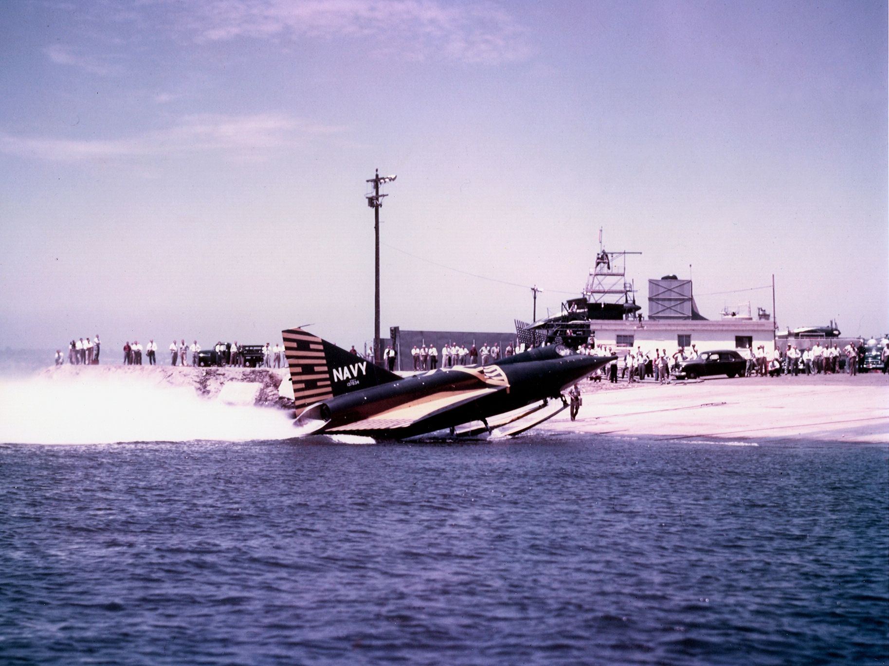 A Convair F2Y Sea Dart landing on shore.