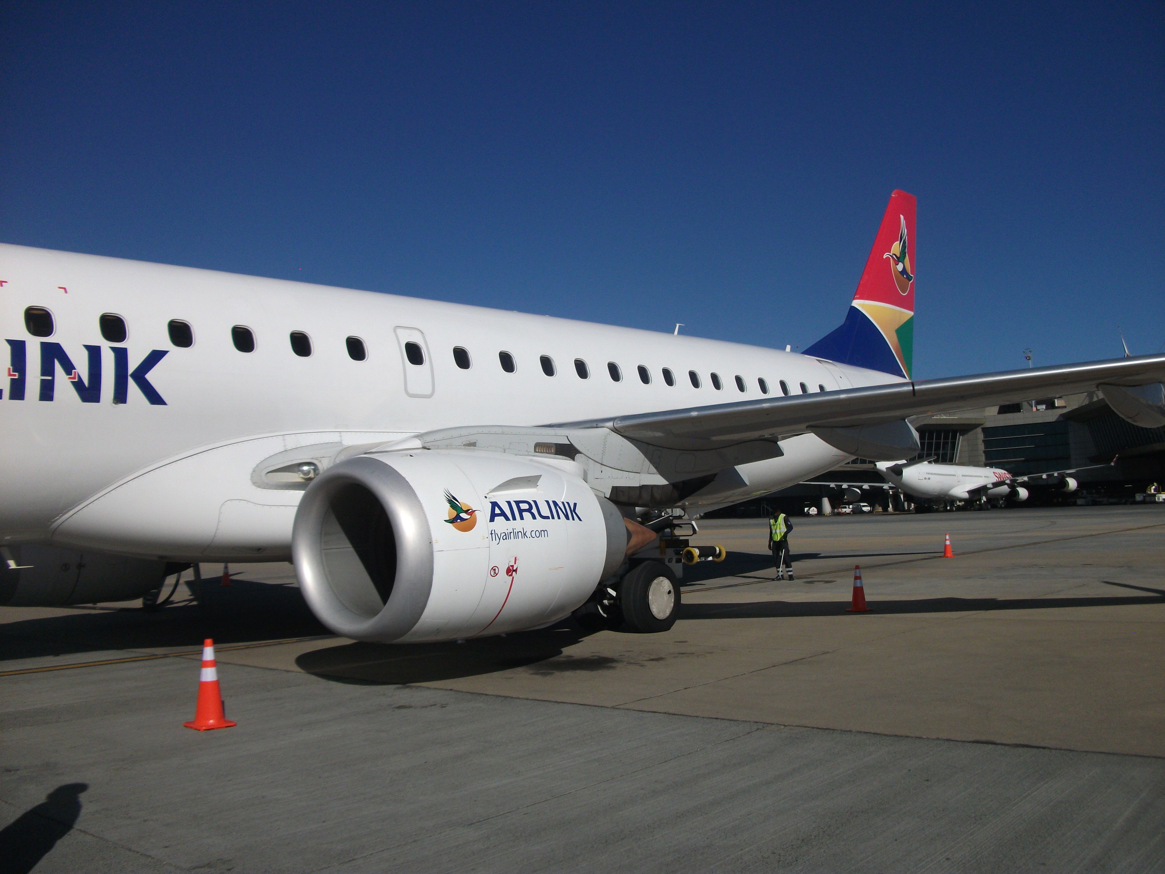 An Airlink Embraer 190 parked at an airport.
