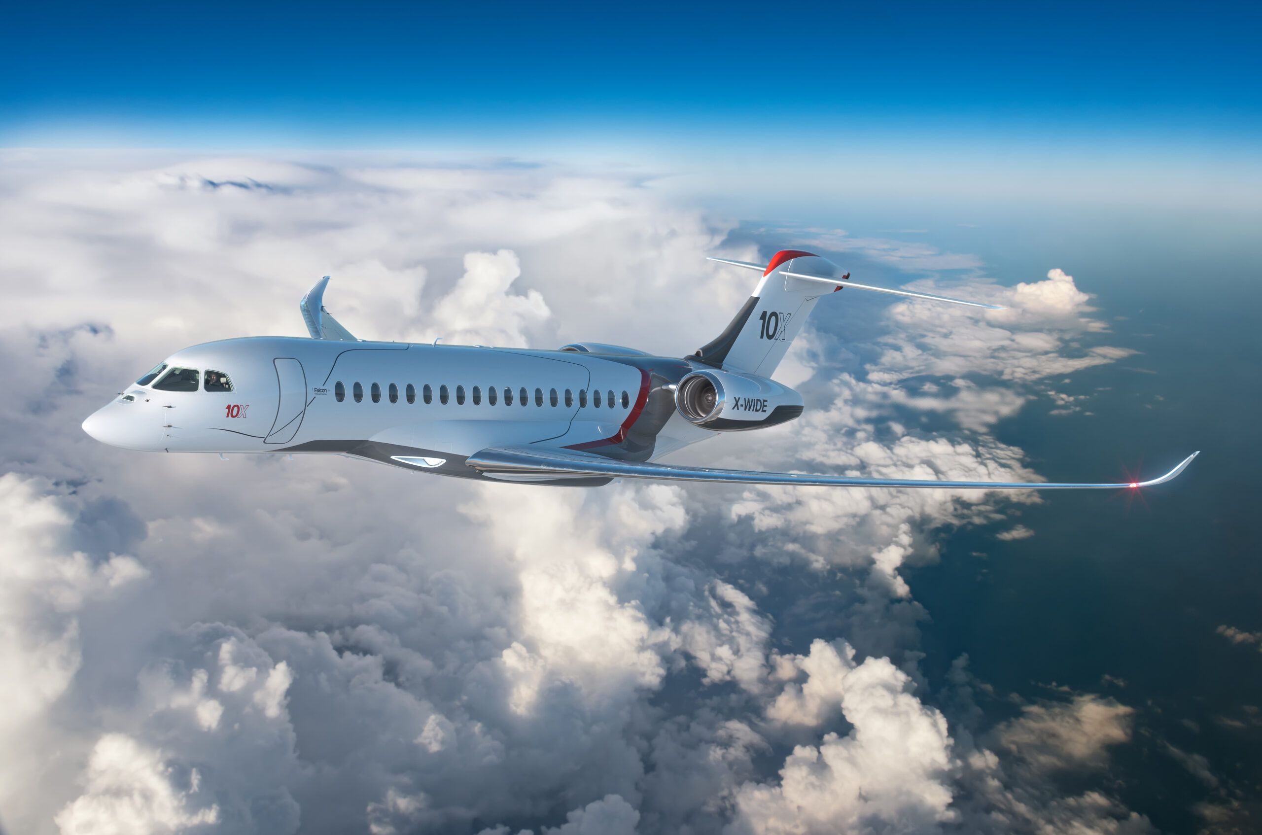 A Dassault Falcon 10X flying above the clouds.