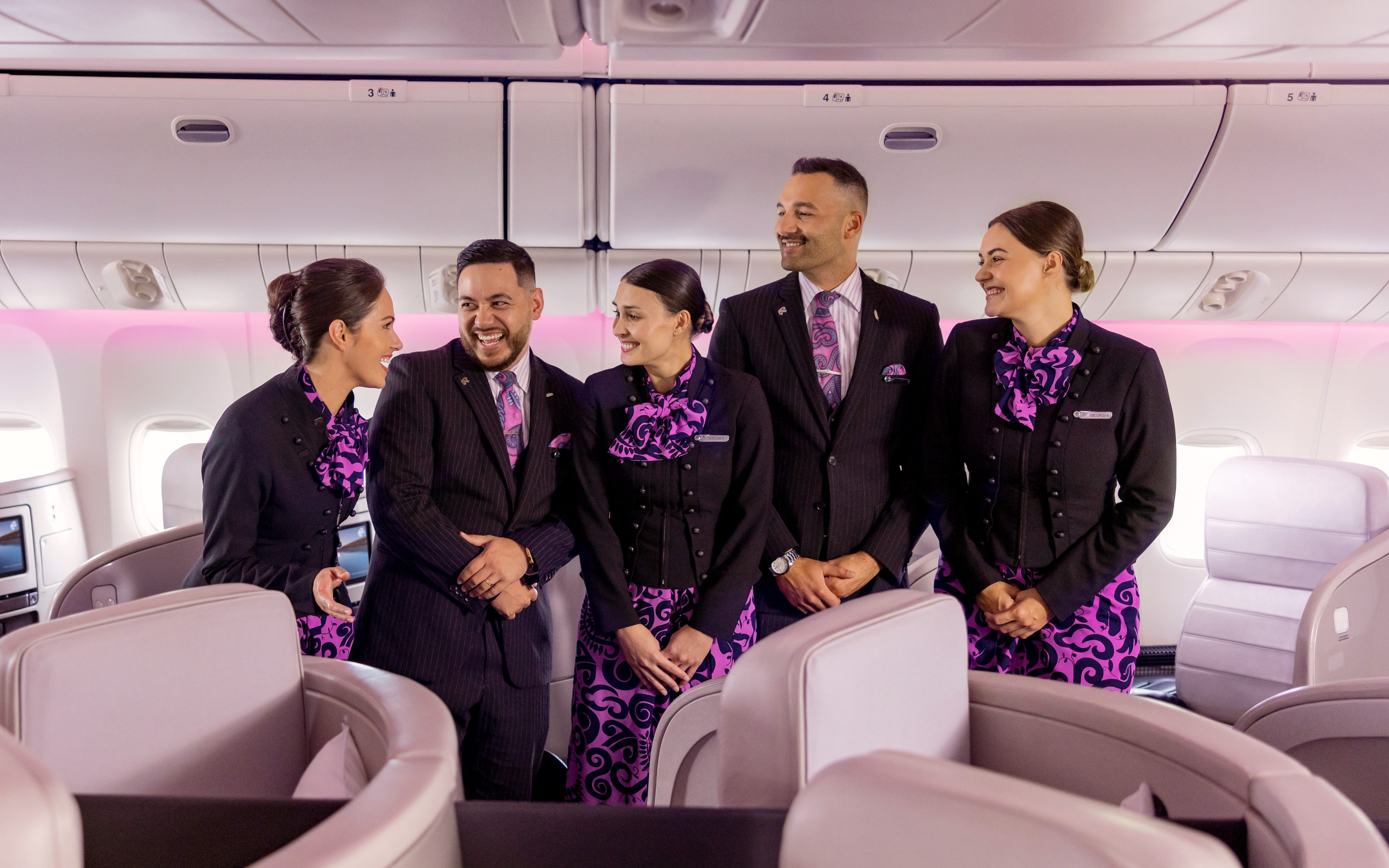 Air New Zealand Cabin Crew In New Uniforms standing in the business class cabin.