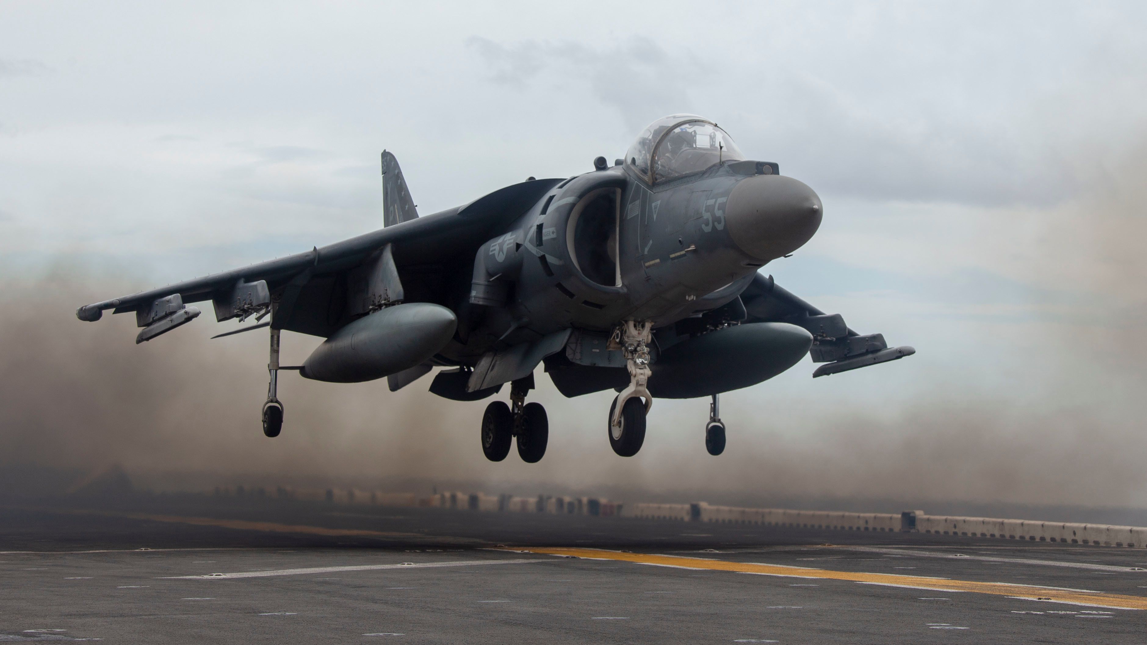 A Harrier jet floating just above the ground.