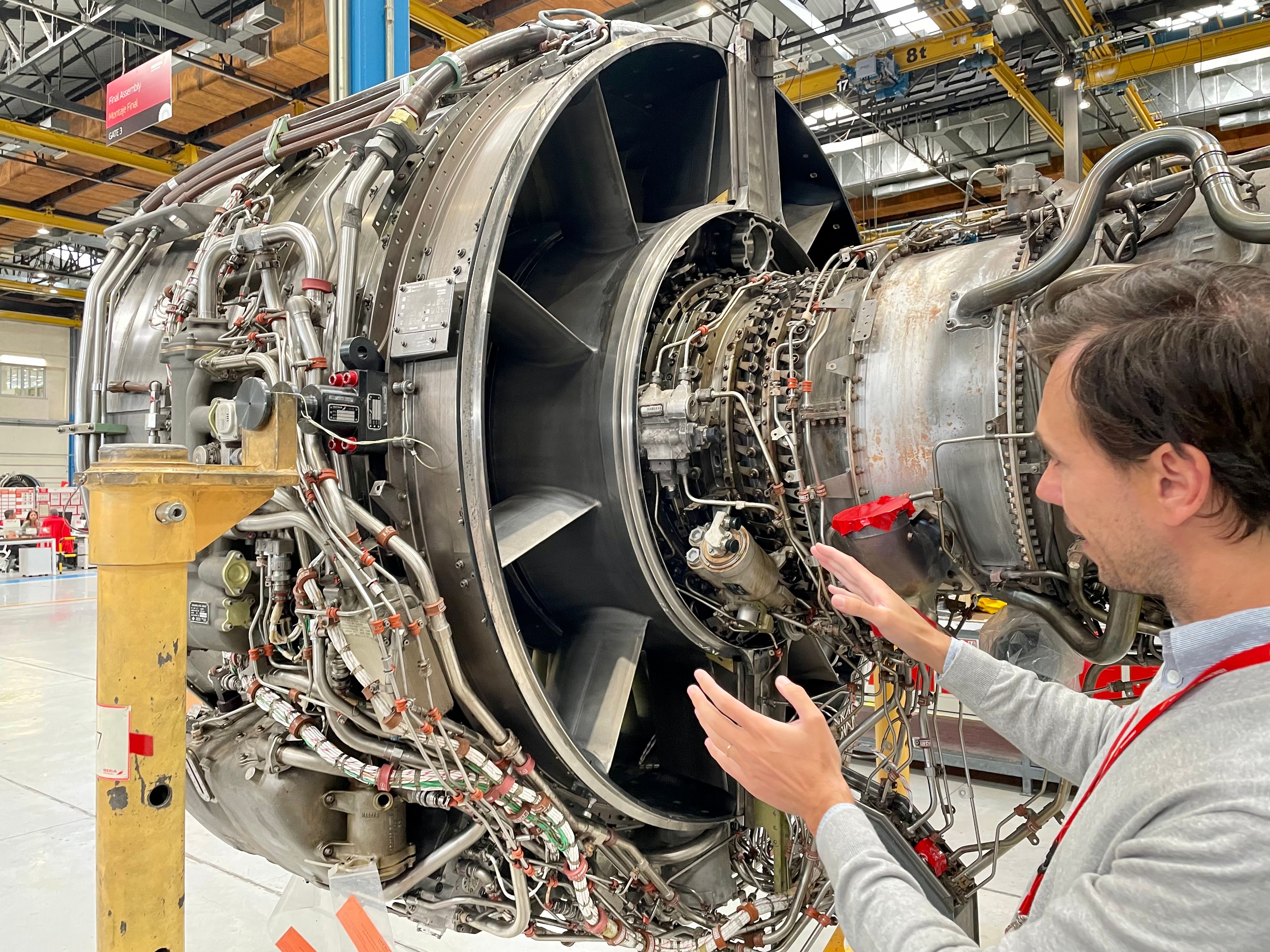 An Iberia Maintenance worker fixing an aircraft engine.