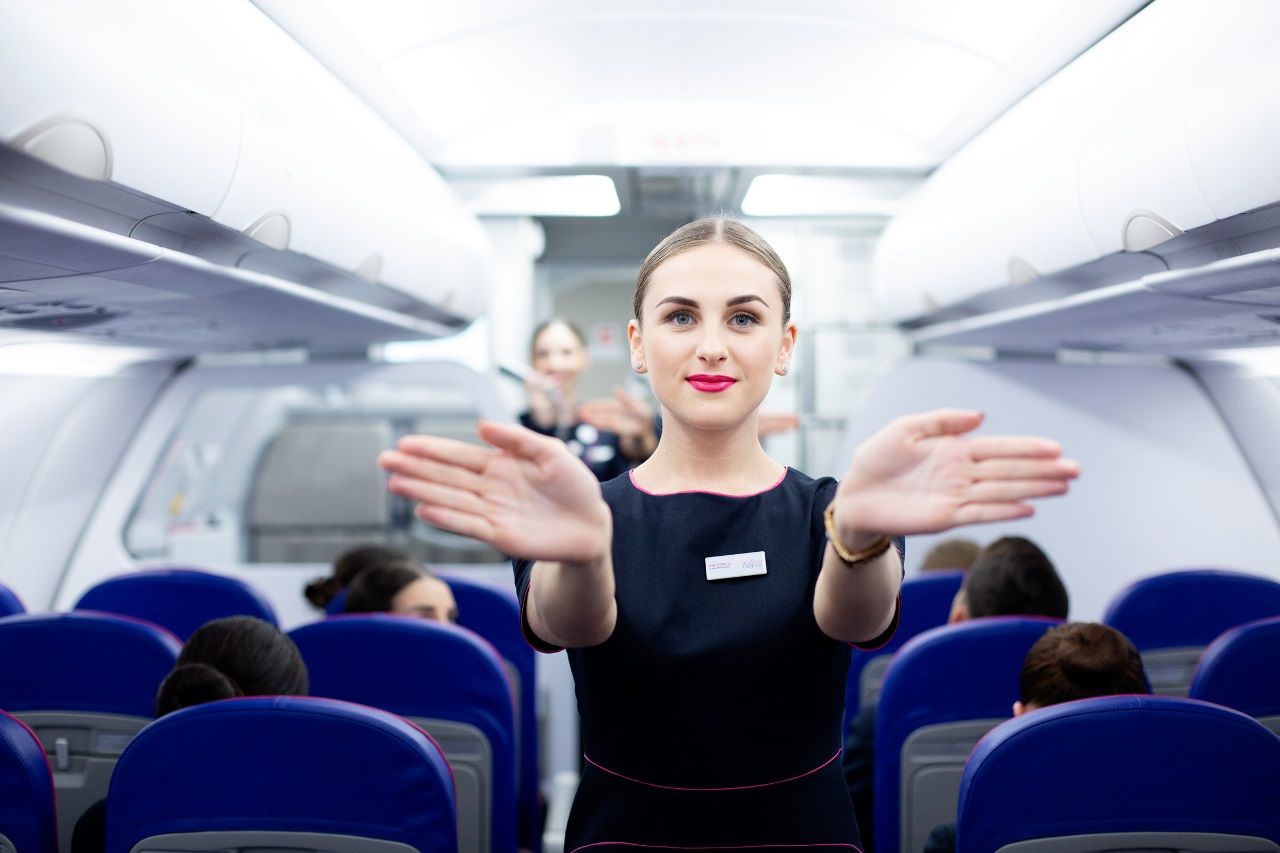 A Wizz Air Cabin crew performing the safety demonstration onboard.