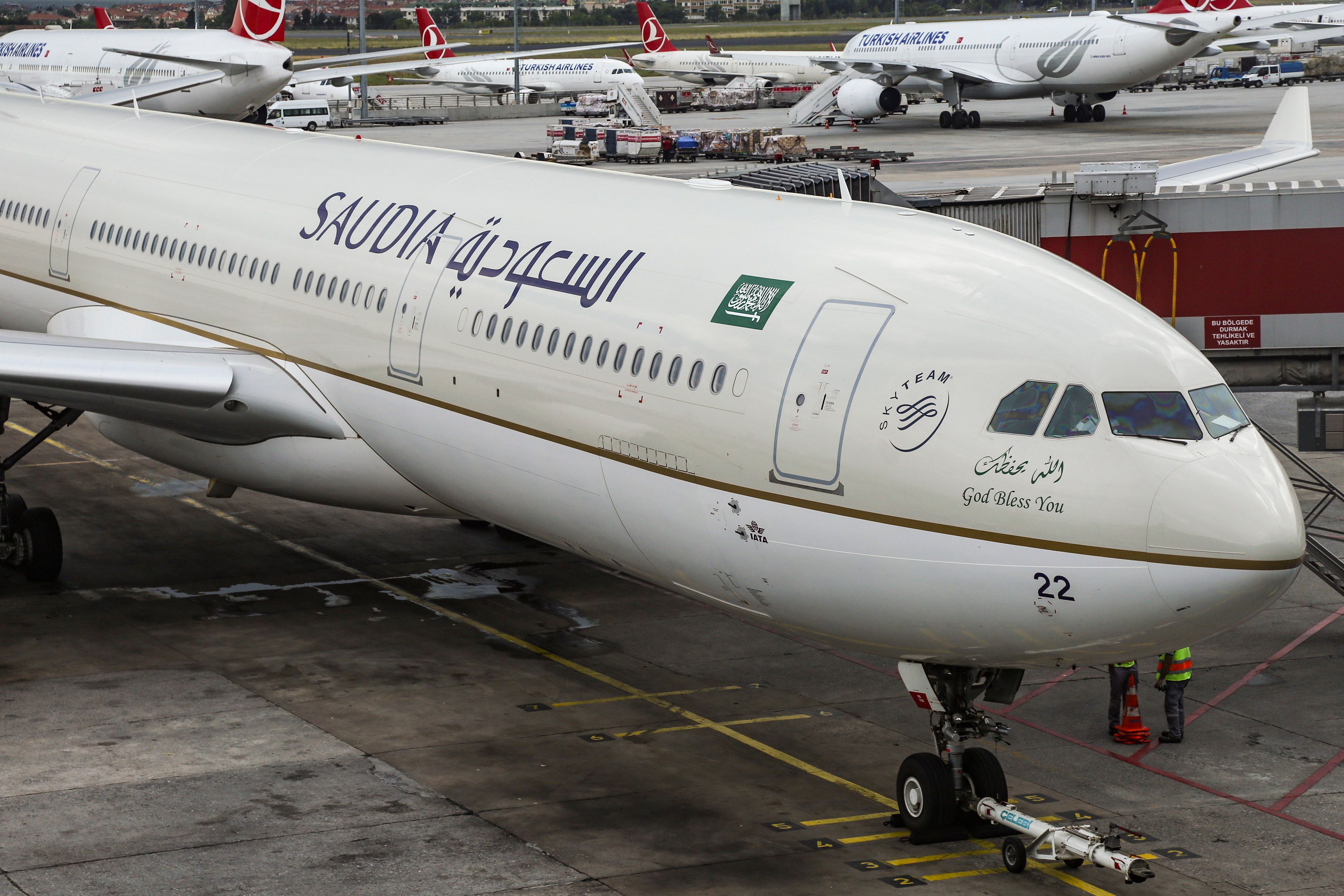 A Saudia Airbus A330 is about to be pushed back from the gate.