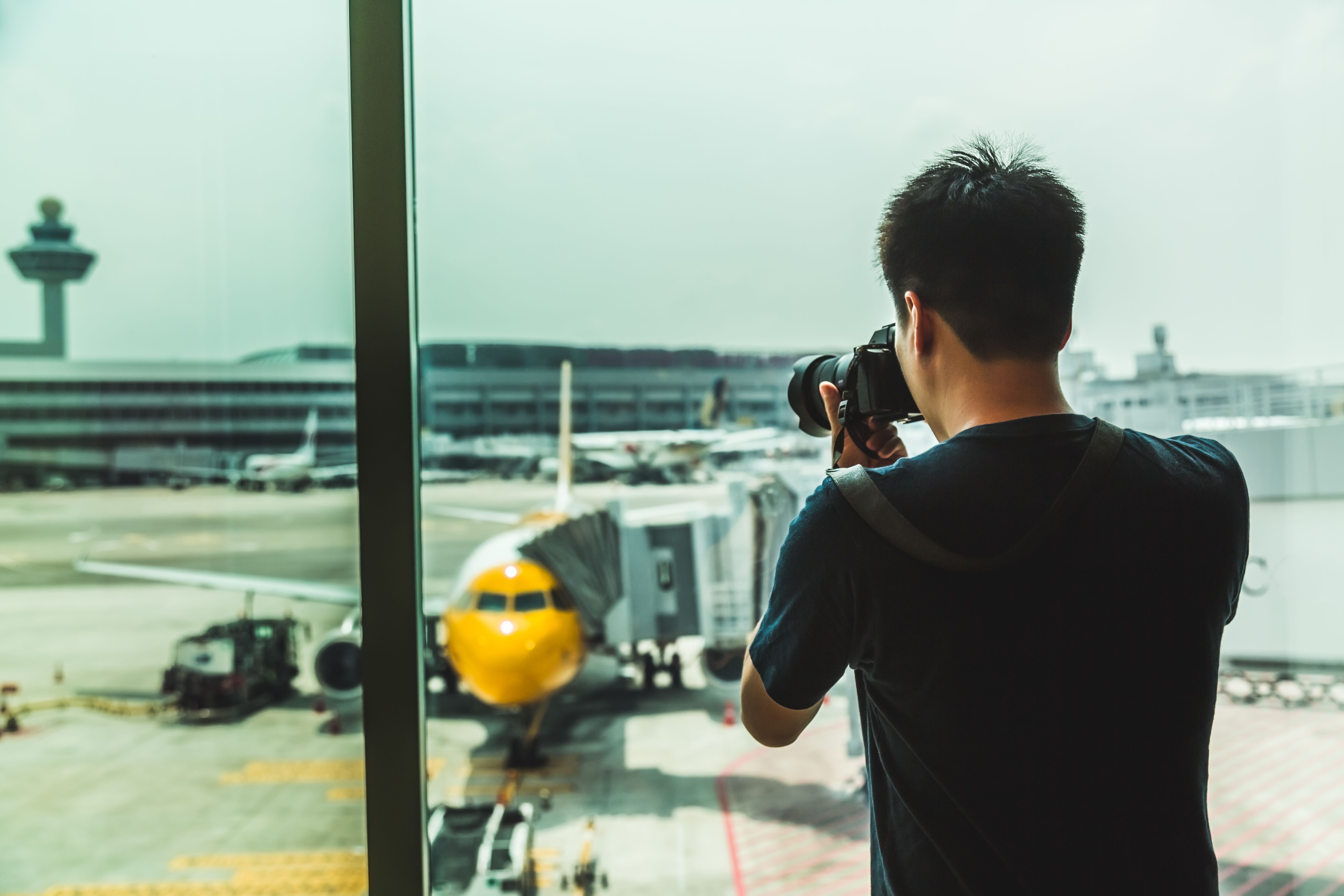 A traveler taking picture of the airplane