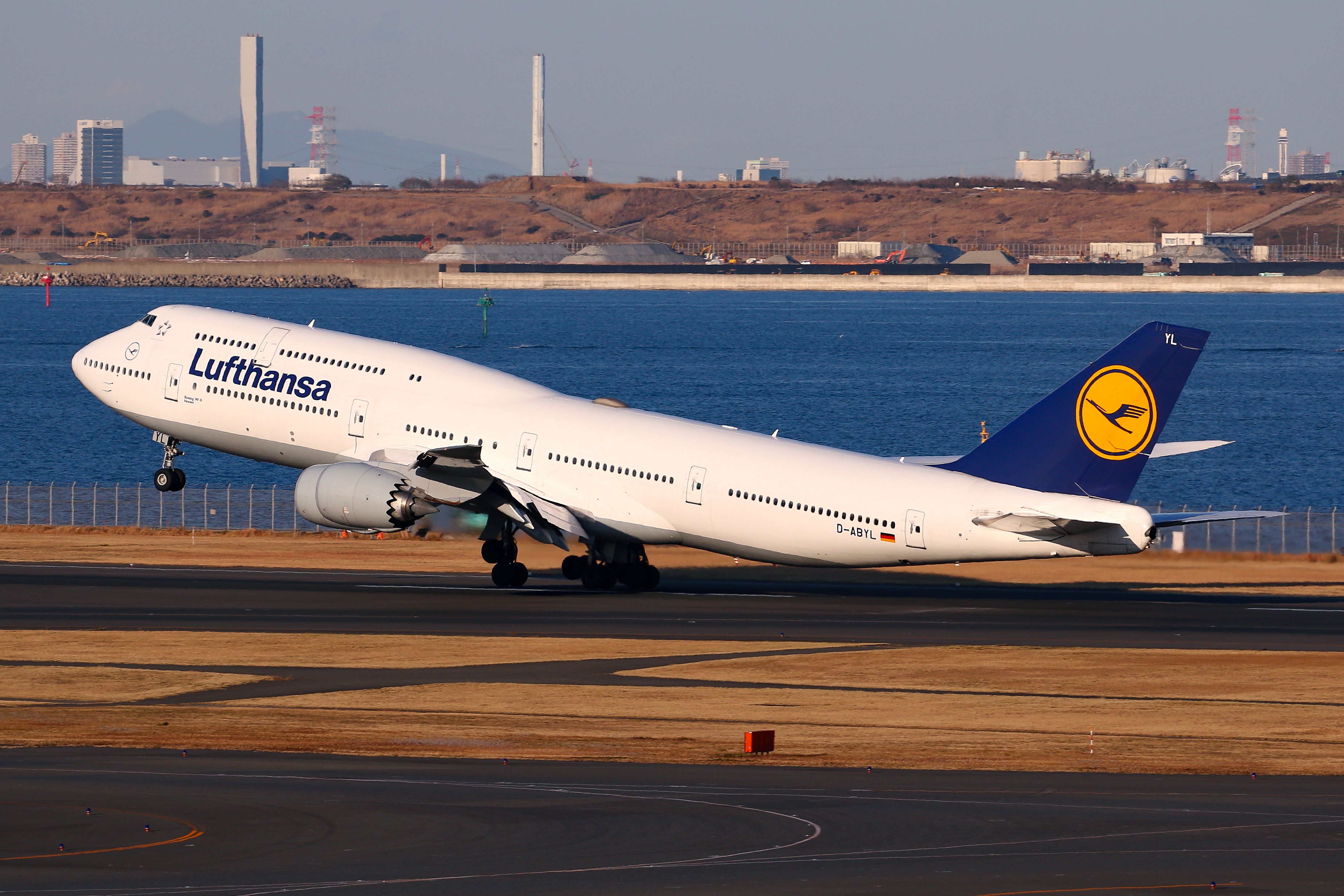 A Lufthansa Boeing 747-8 taking off at Tokyo Haneda Airport.