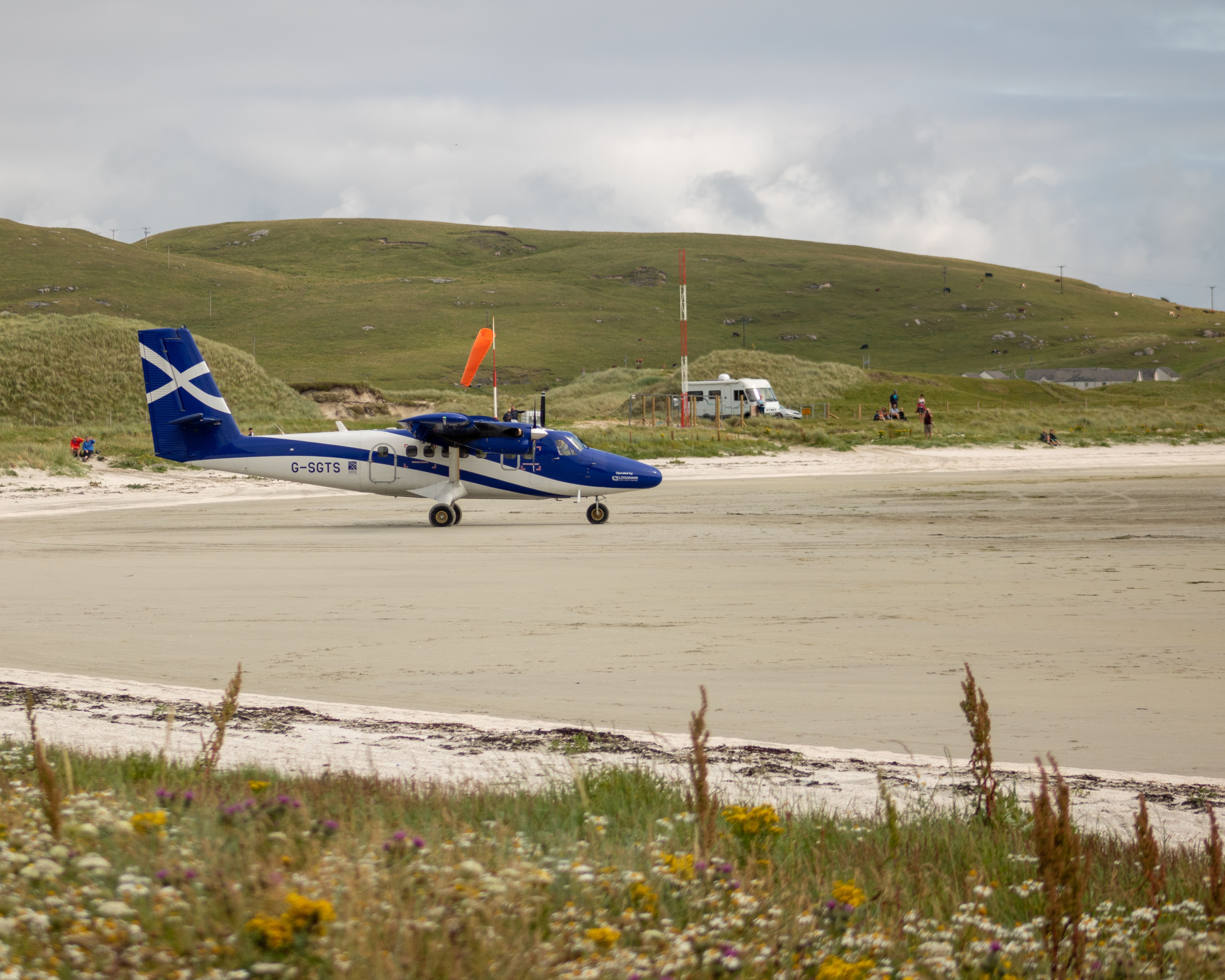 Barra Airport, Outer Hebrides, Scotland - a Loganair Twin Otter lands