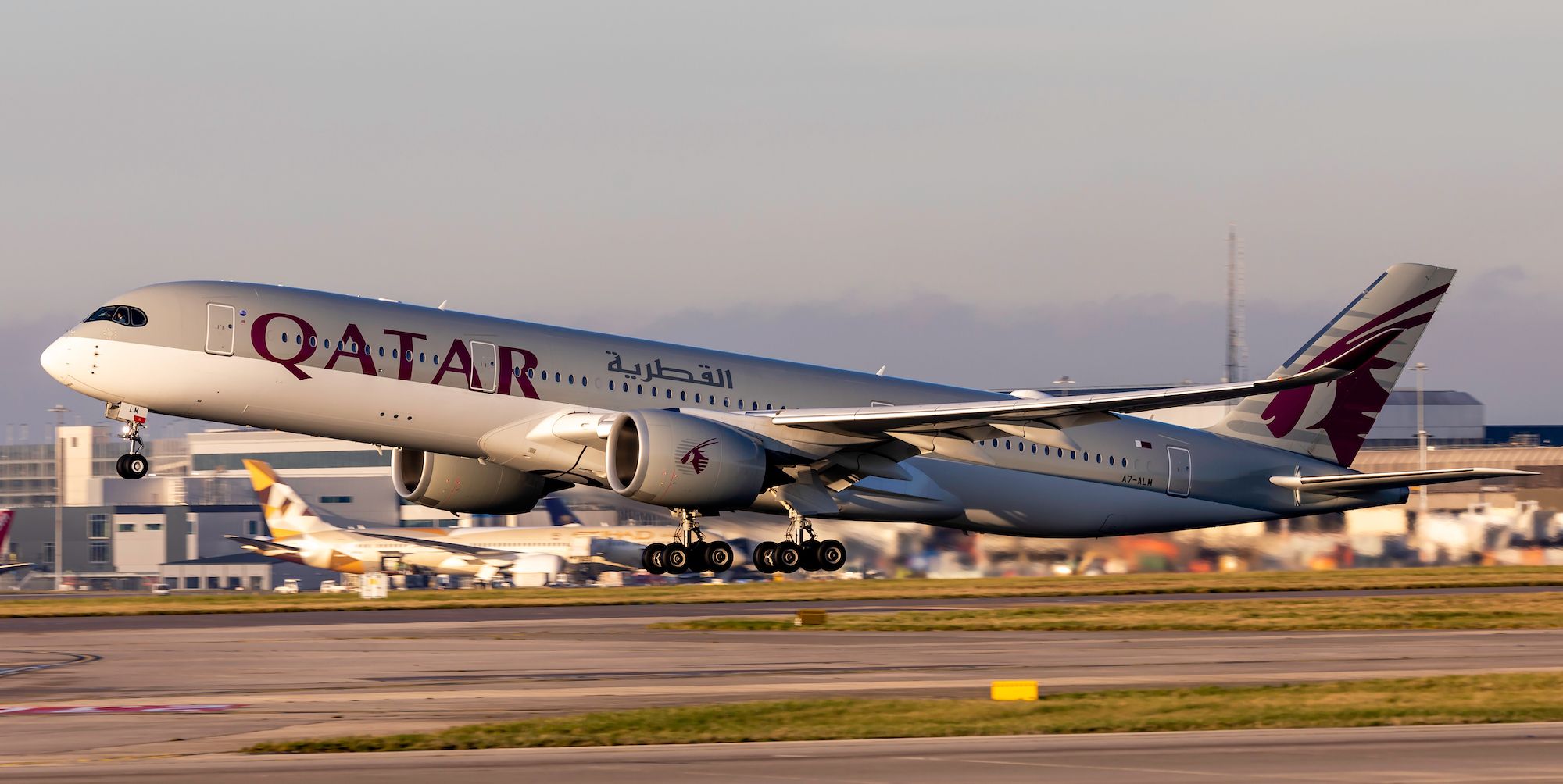 Qatar Airways Airbus A350 taking off towards the sun