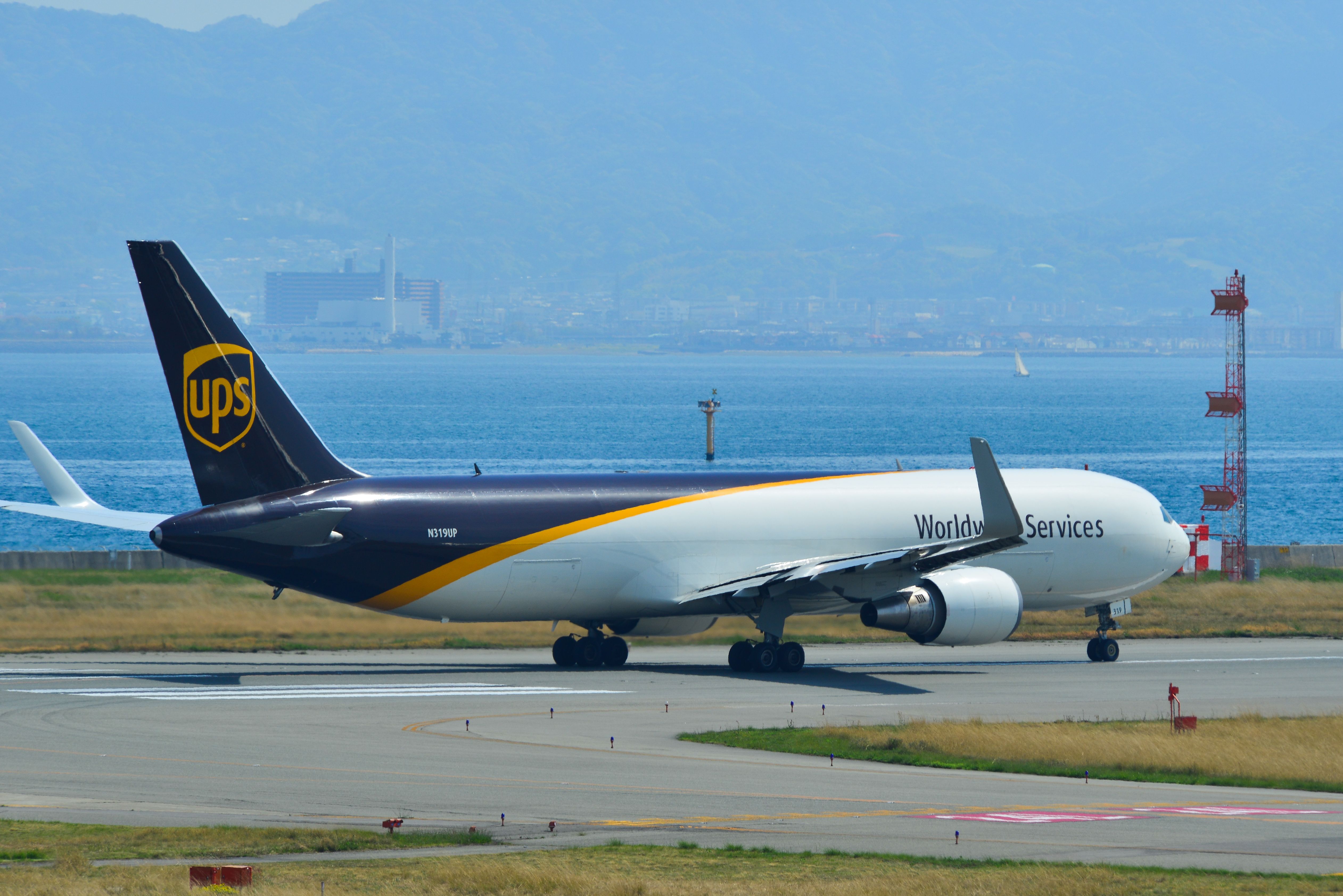 United Parcel Service (UPS) Boeing 767-300F taxiing on runway of Kansai Airport.