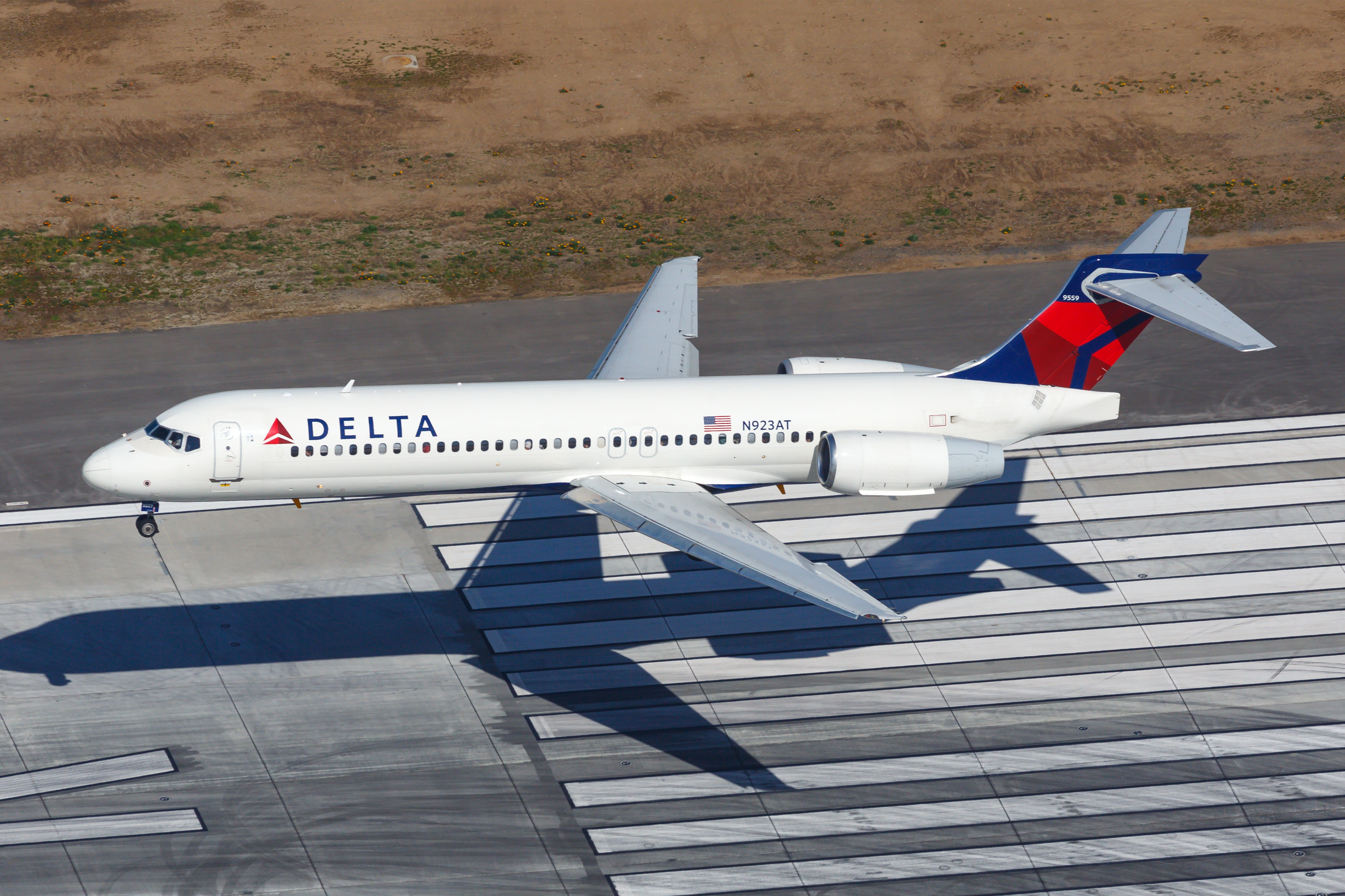 A Delta Air Lines Boeing 717 about to land on a runway.