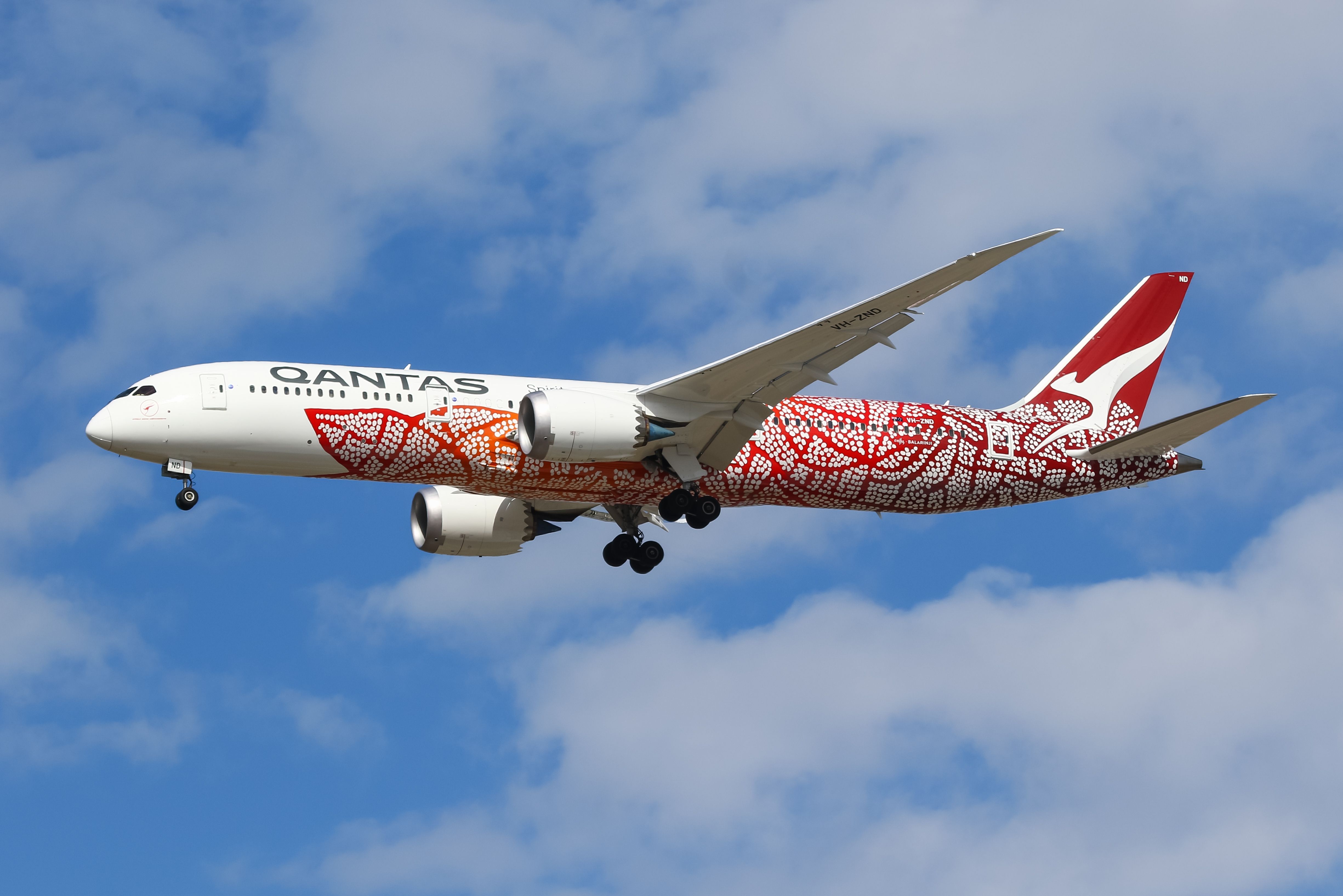 A Qantas Boeing 787-9 flying in the sky.