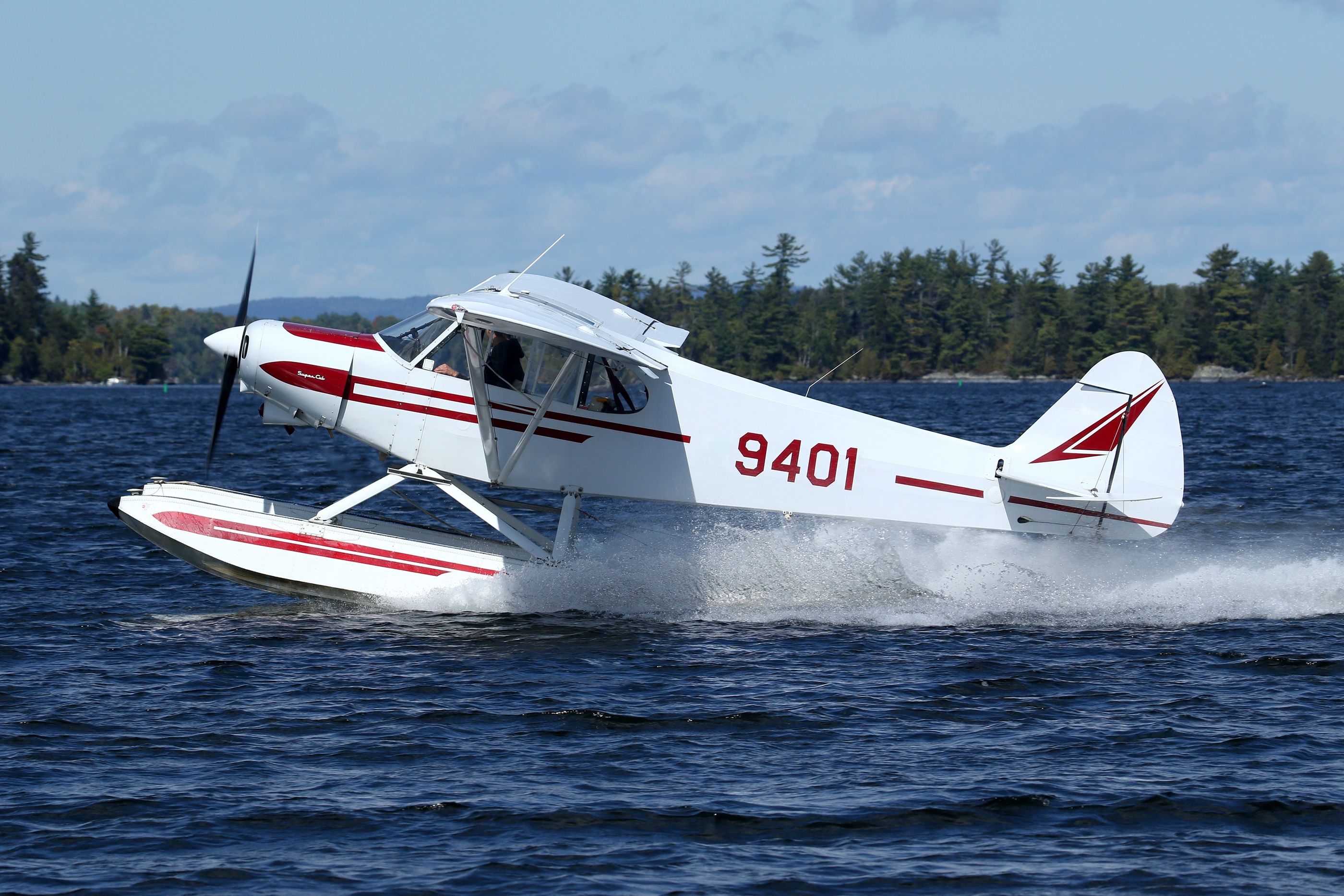 A Piper PA-18 Super Cub Float Plane, Taking Off from Moosehead Lake, Greenville, ME, USA. (September 2021)