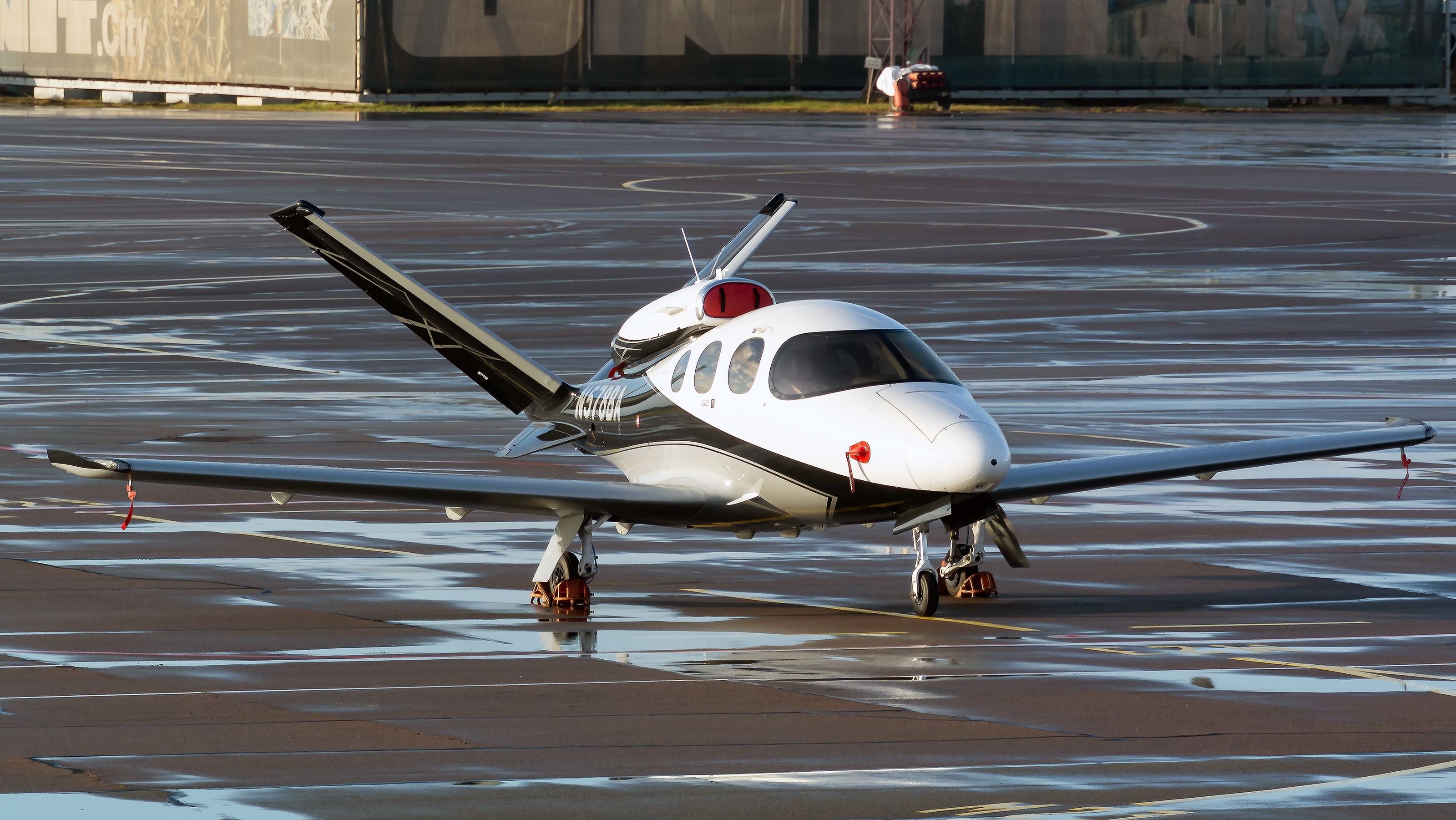 A Cirrus SF50 Vision Jet taxiing at an airport.