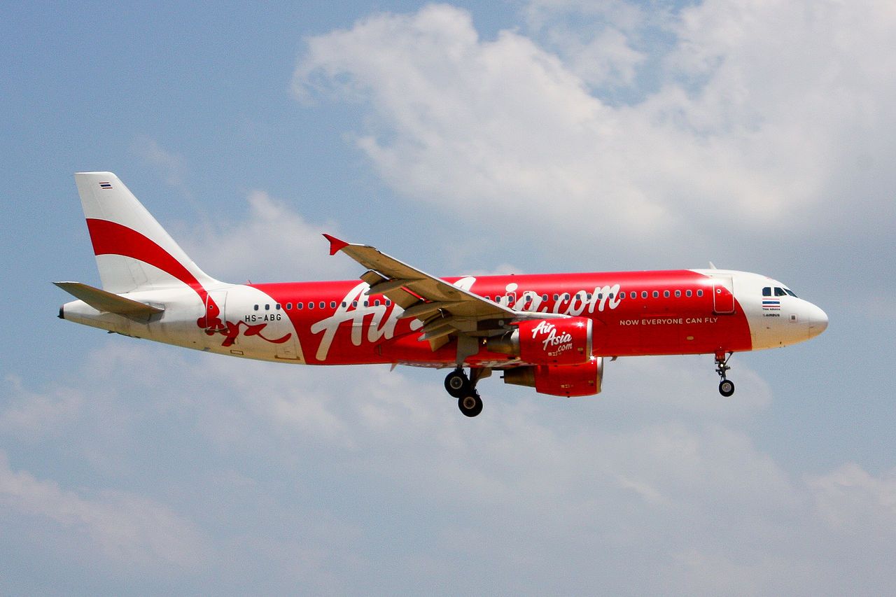 A Thai AirAsia Airbus A320 flying in the sky.