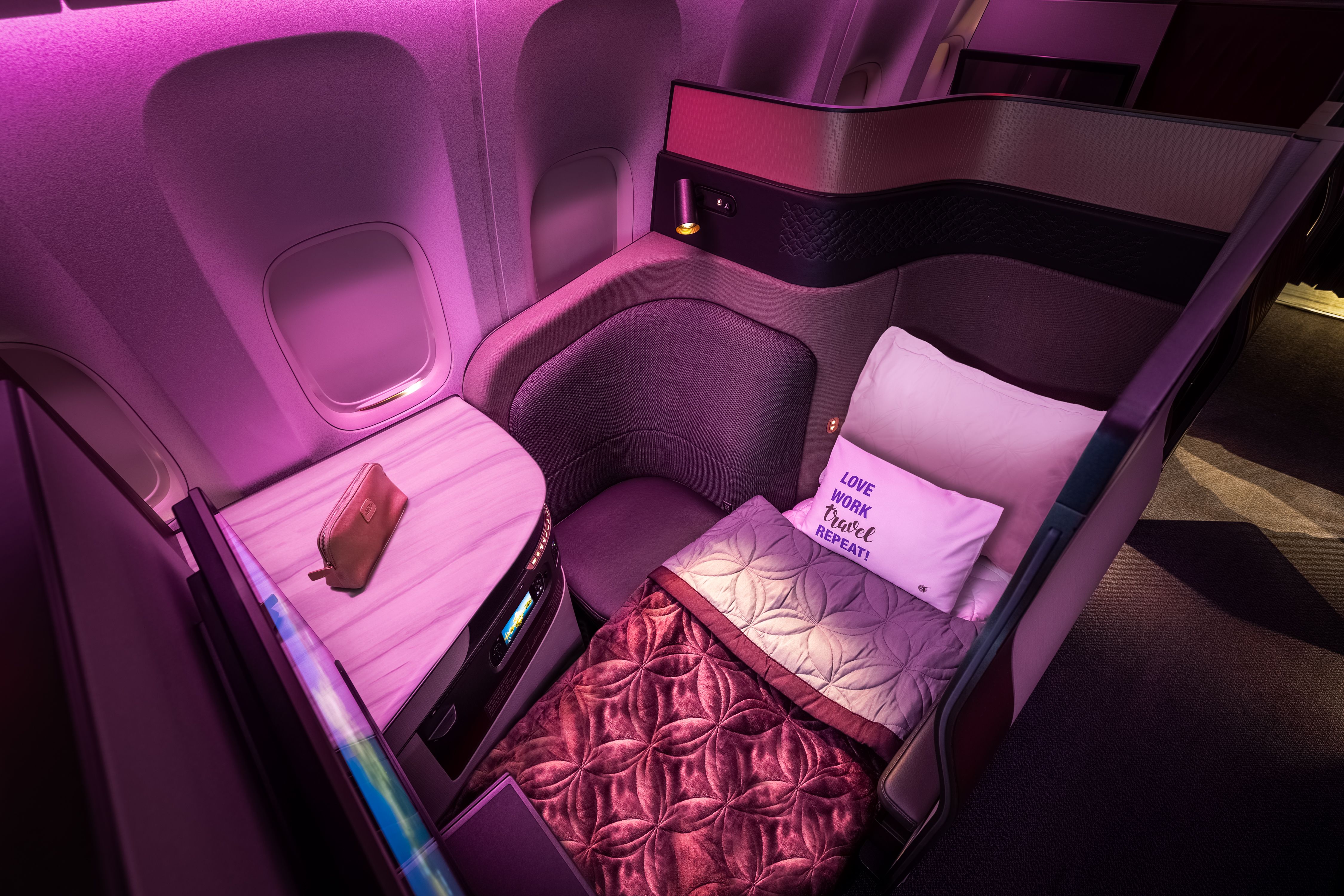 An overhead view of a Qatar Airways Qsuite business class suite.