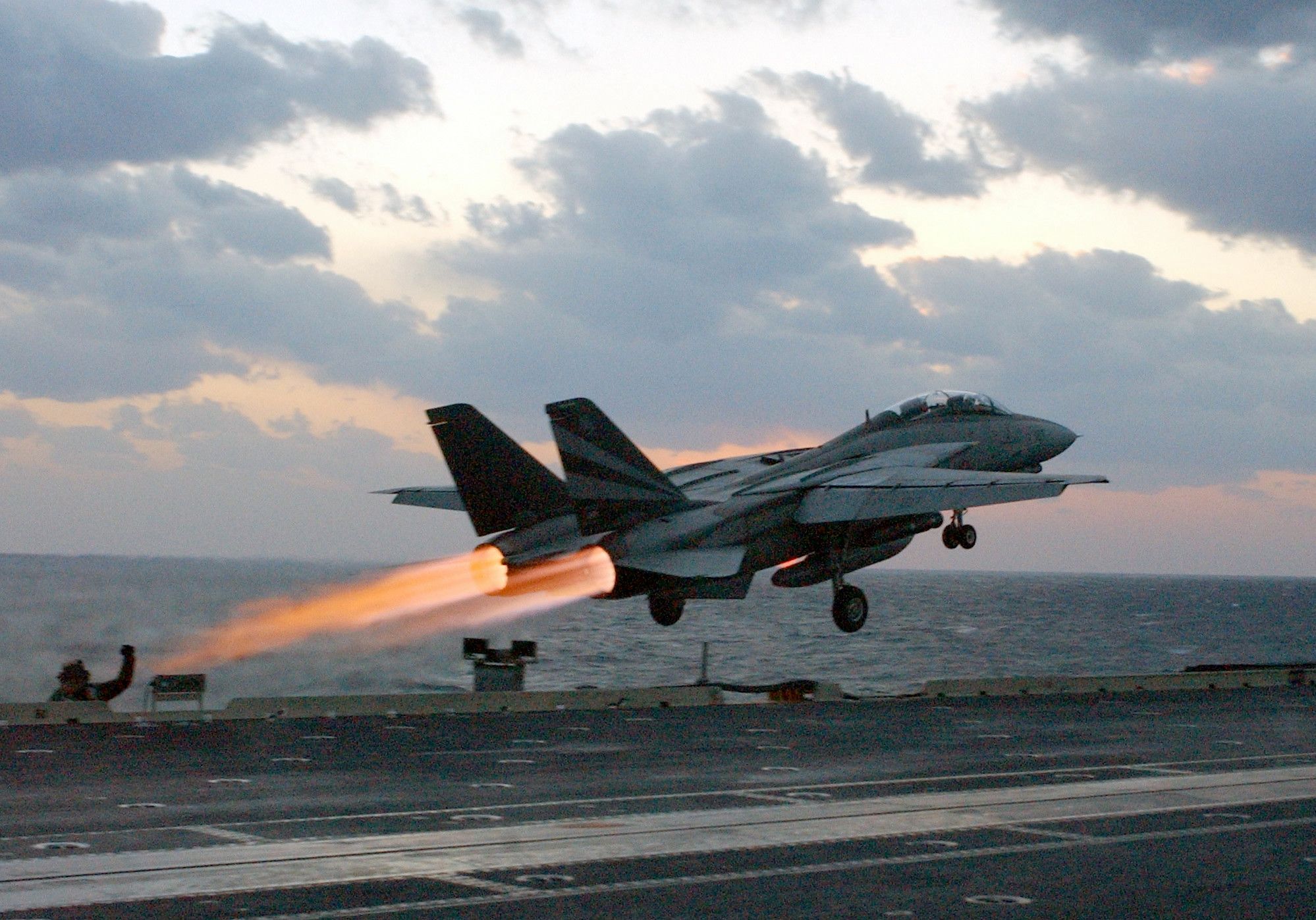 A F-14 Tomcat taking off from an aircraft carrier.