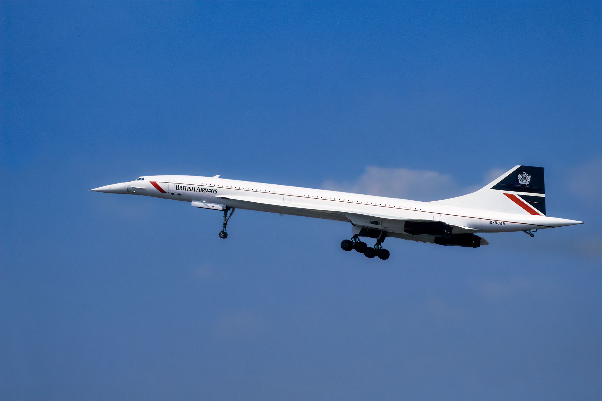 A British Airways Concorde taking off with landing gear still extended.