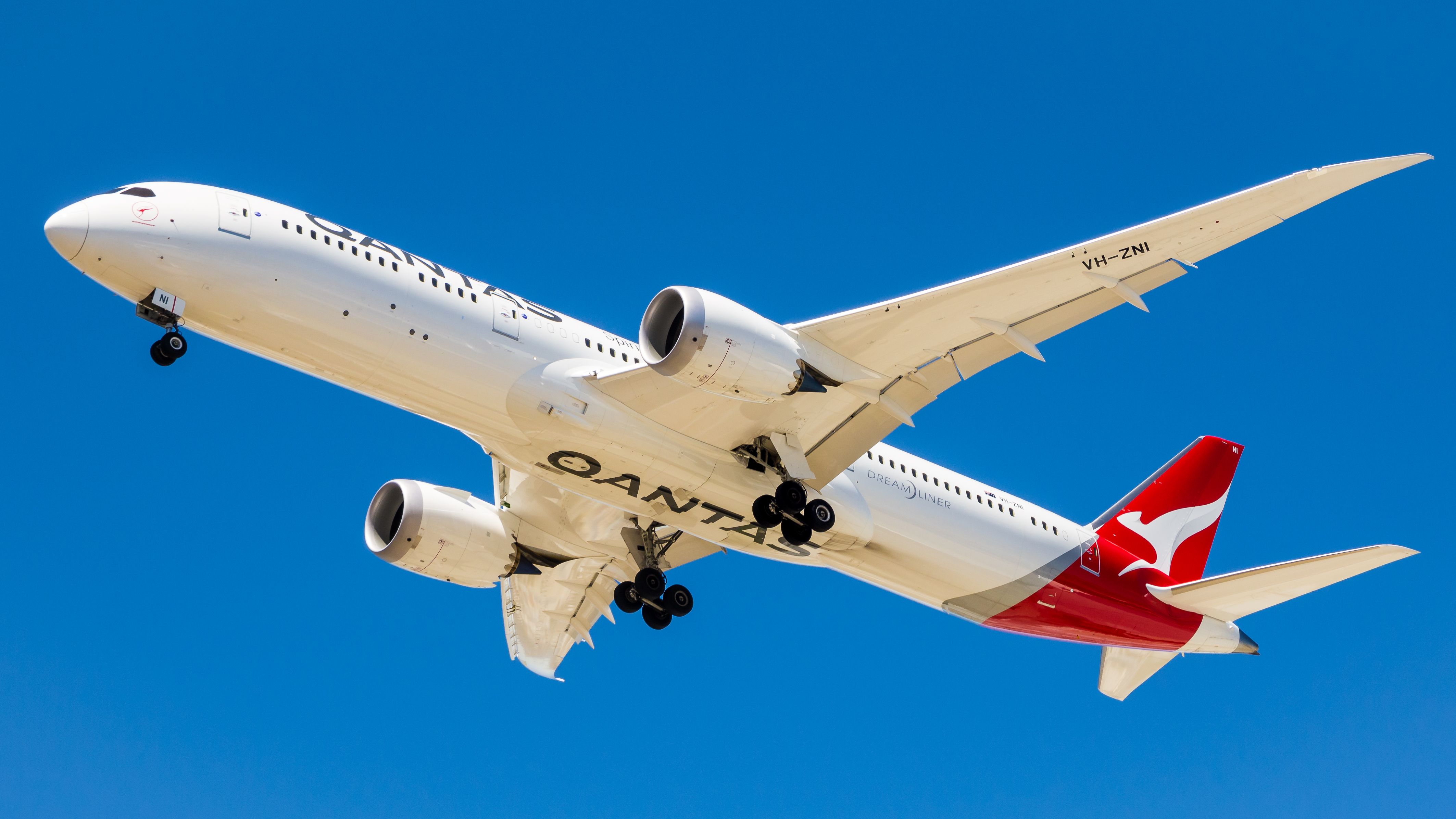 A Qantas Boeing 787 Dreamliner flying in the sky.