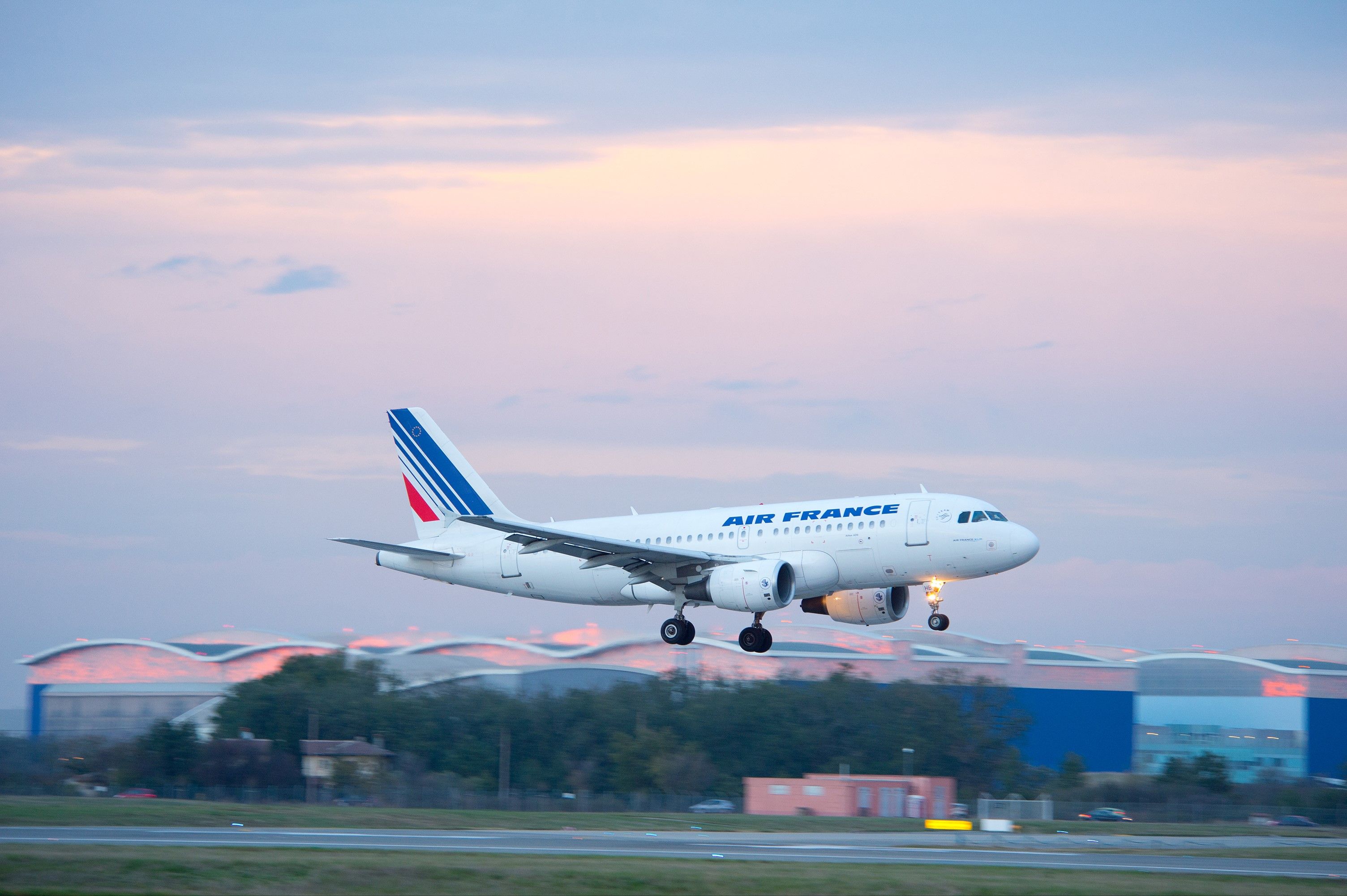 An Air France Airbus A320 Landing during sunset.