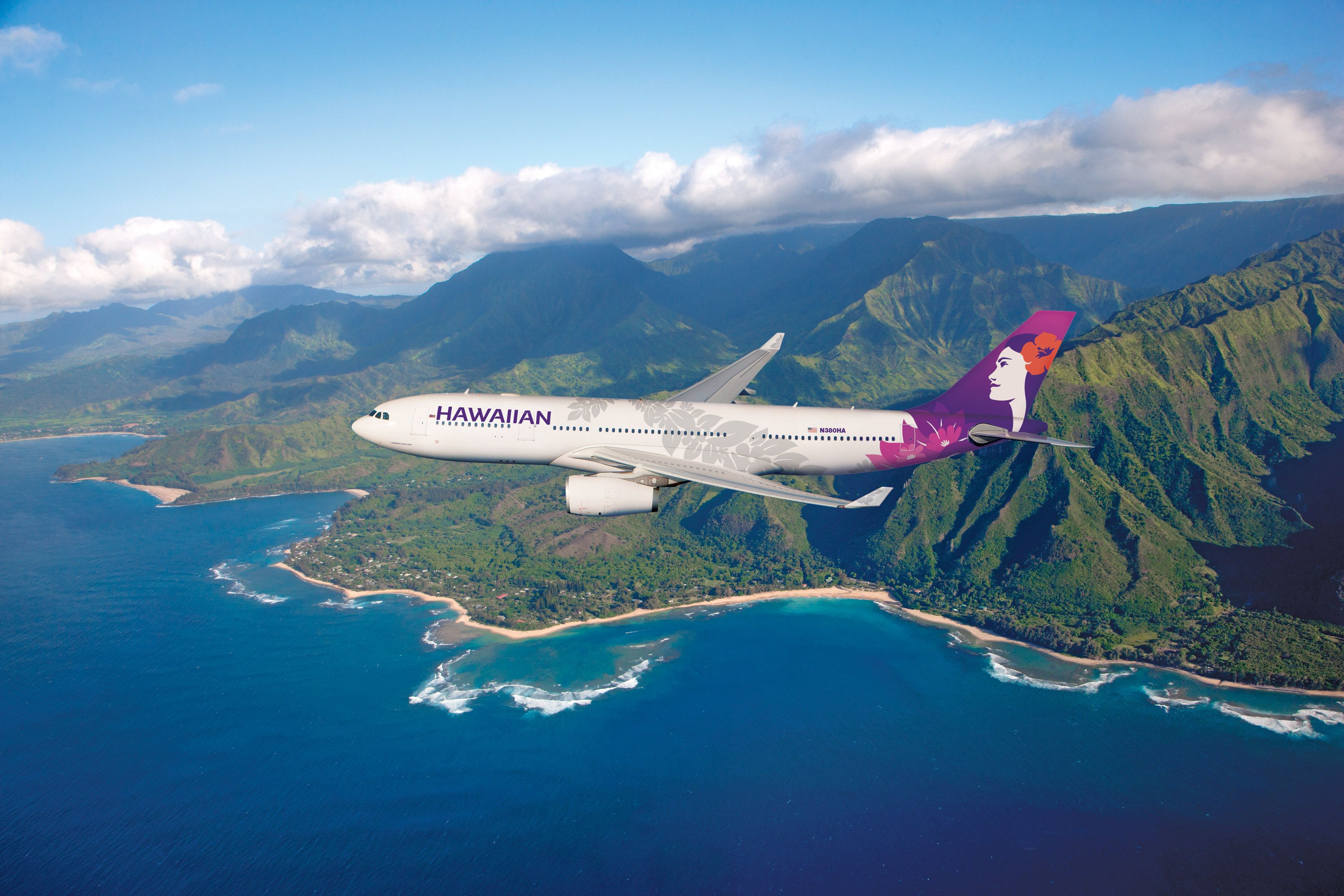 A Hawaian Airlines Airbus A330 flying along the coast.