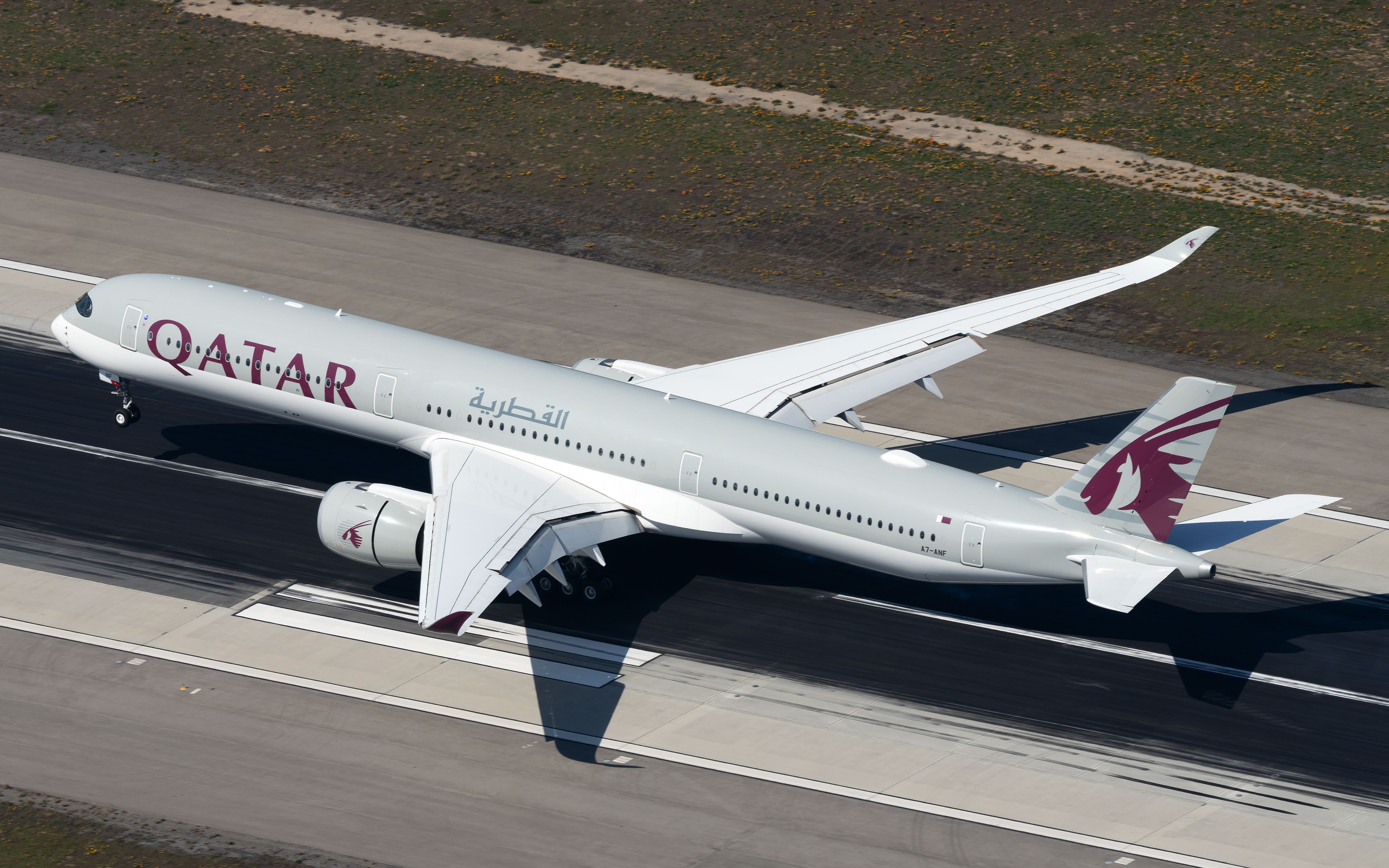 A Qatar Airways Airbus A350-1000 on an airport runway.