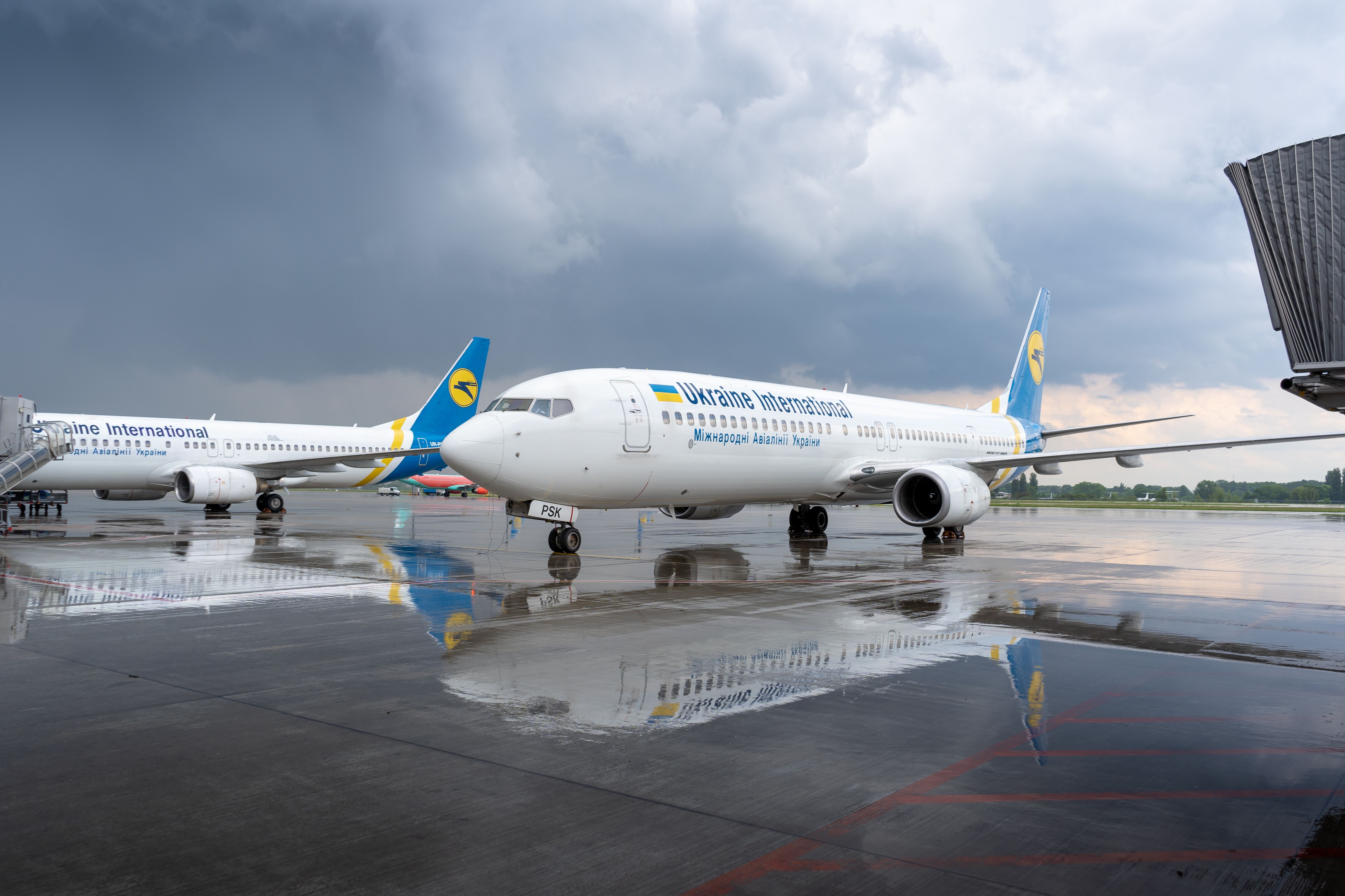 An Ukraininan Internaional Airlines Boeing 737-900ER on the Boryspil airport apron runway in a rainy weather 