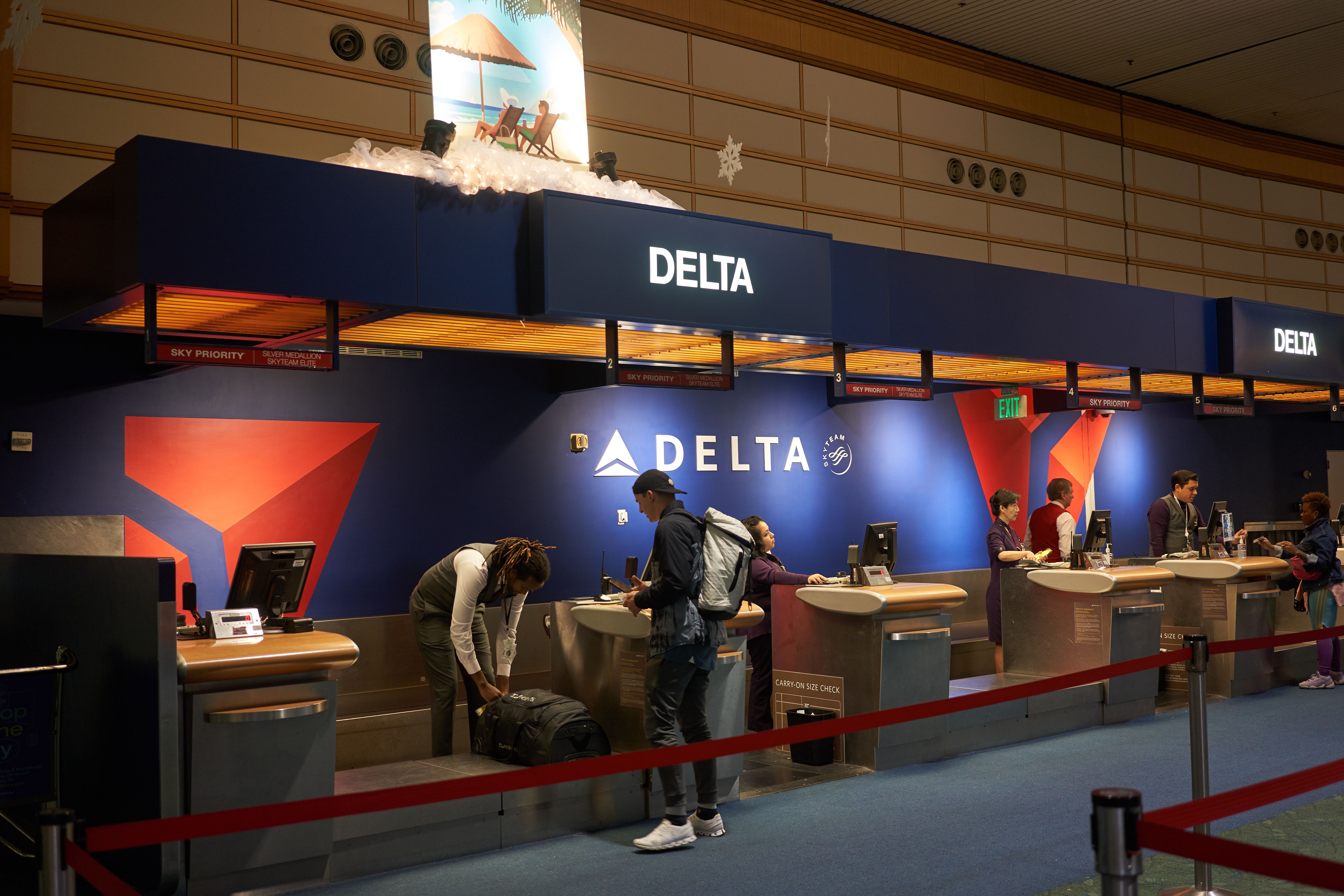 A Passenger checking in at a Delta Air Lines counter.