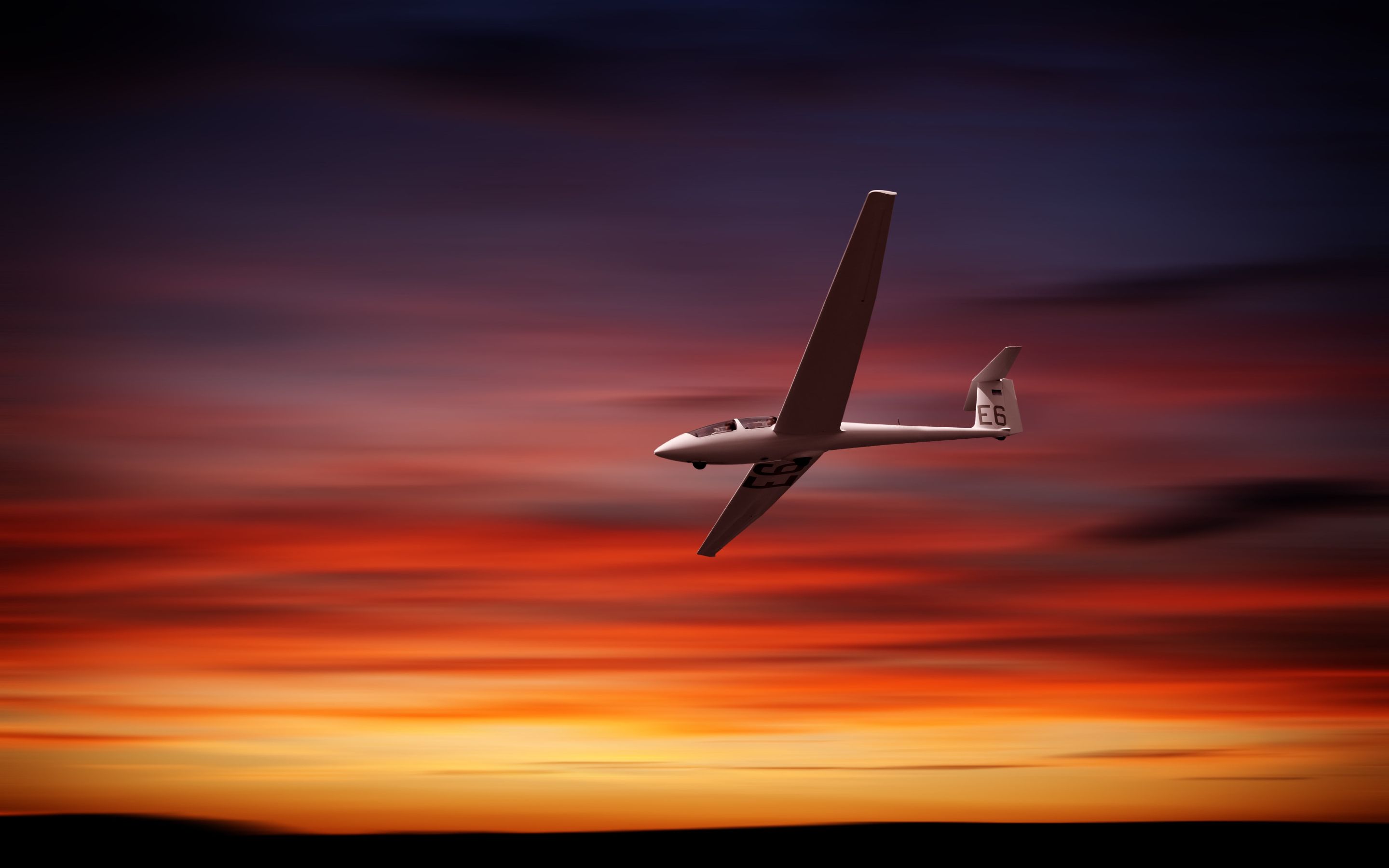 Glider flying at sunset