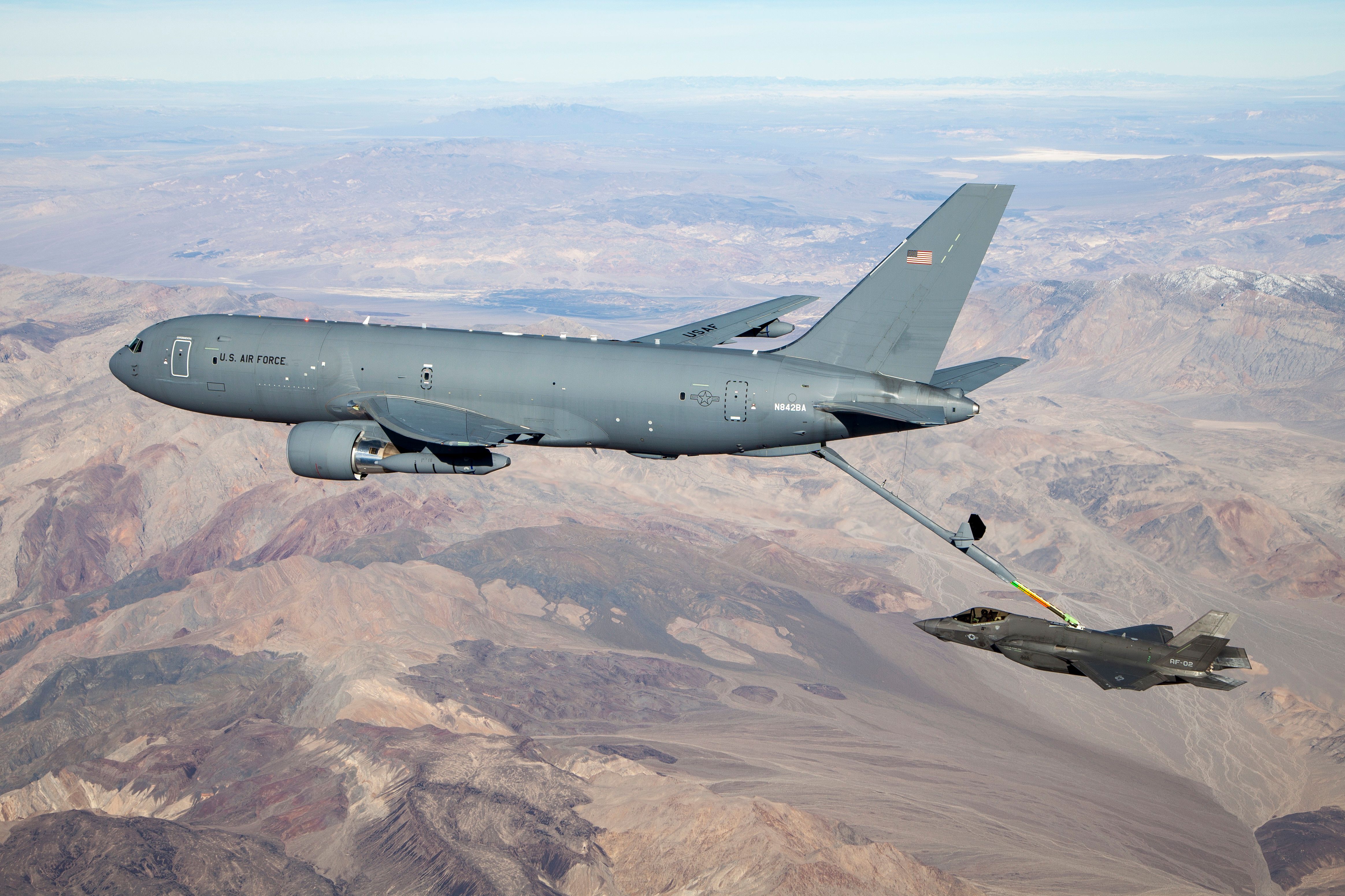 A KC-46 refueling an F-35 over mountainous terrain.