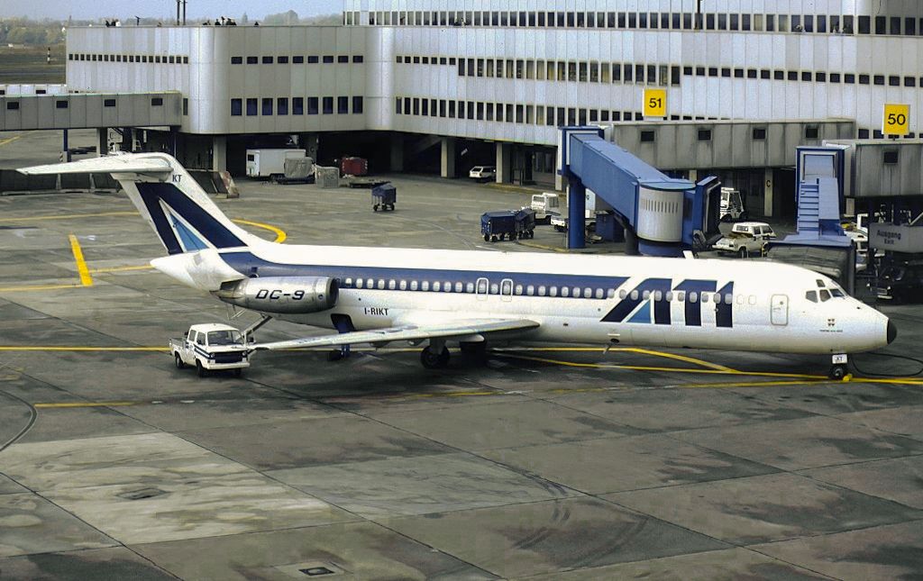 An ATI Aero Trasporti Italiani McDonnell Douglas DC-9-32 parked at an airport.