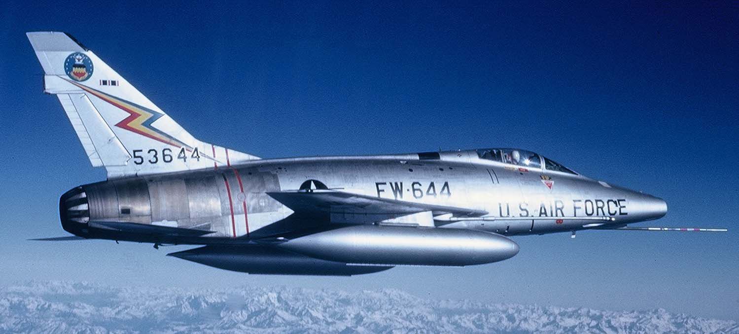 A North American F-100 Super Sabre flying above the clouds.