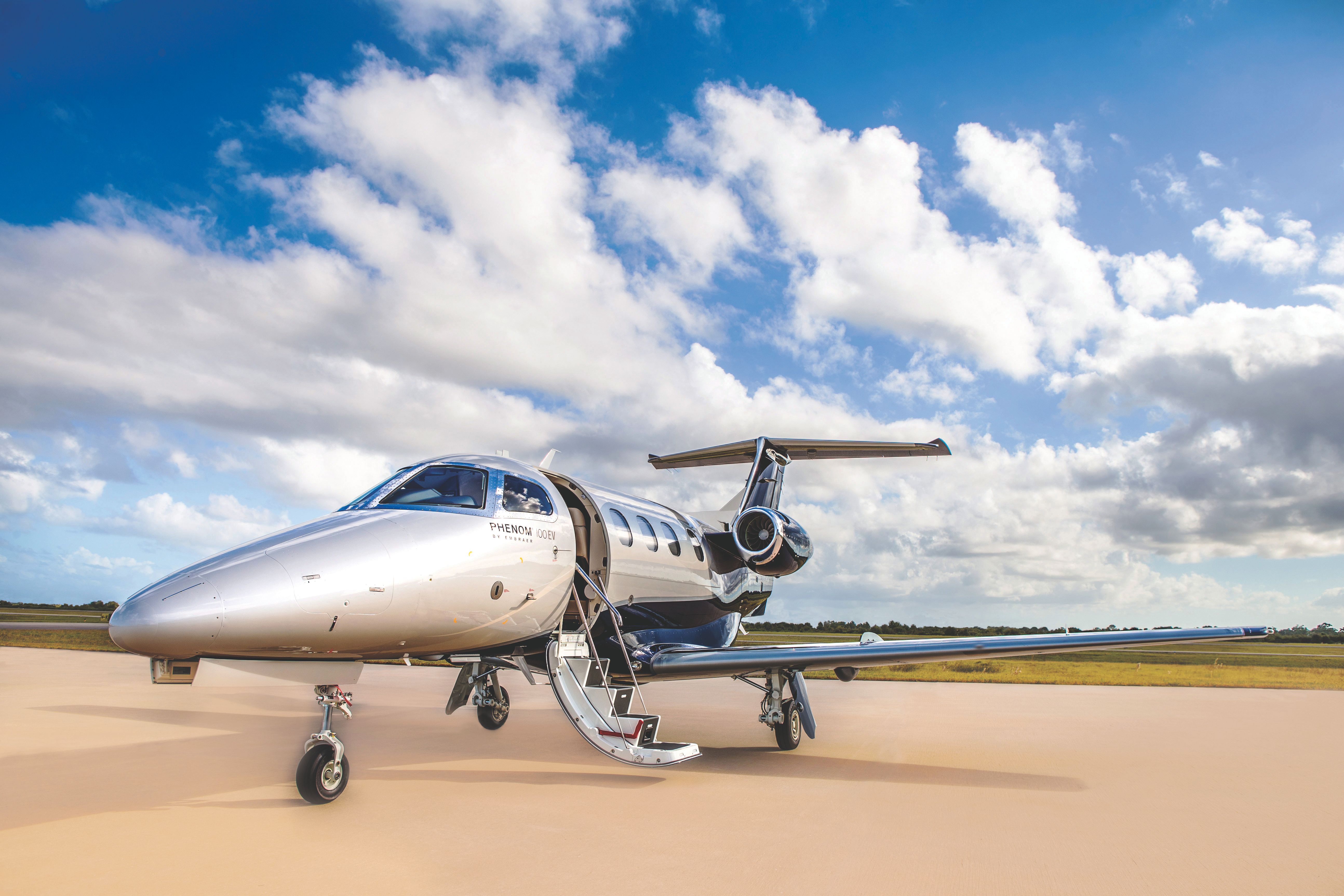 An Embraer Phenom 100EV parked at an airfield.