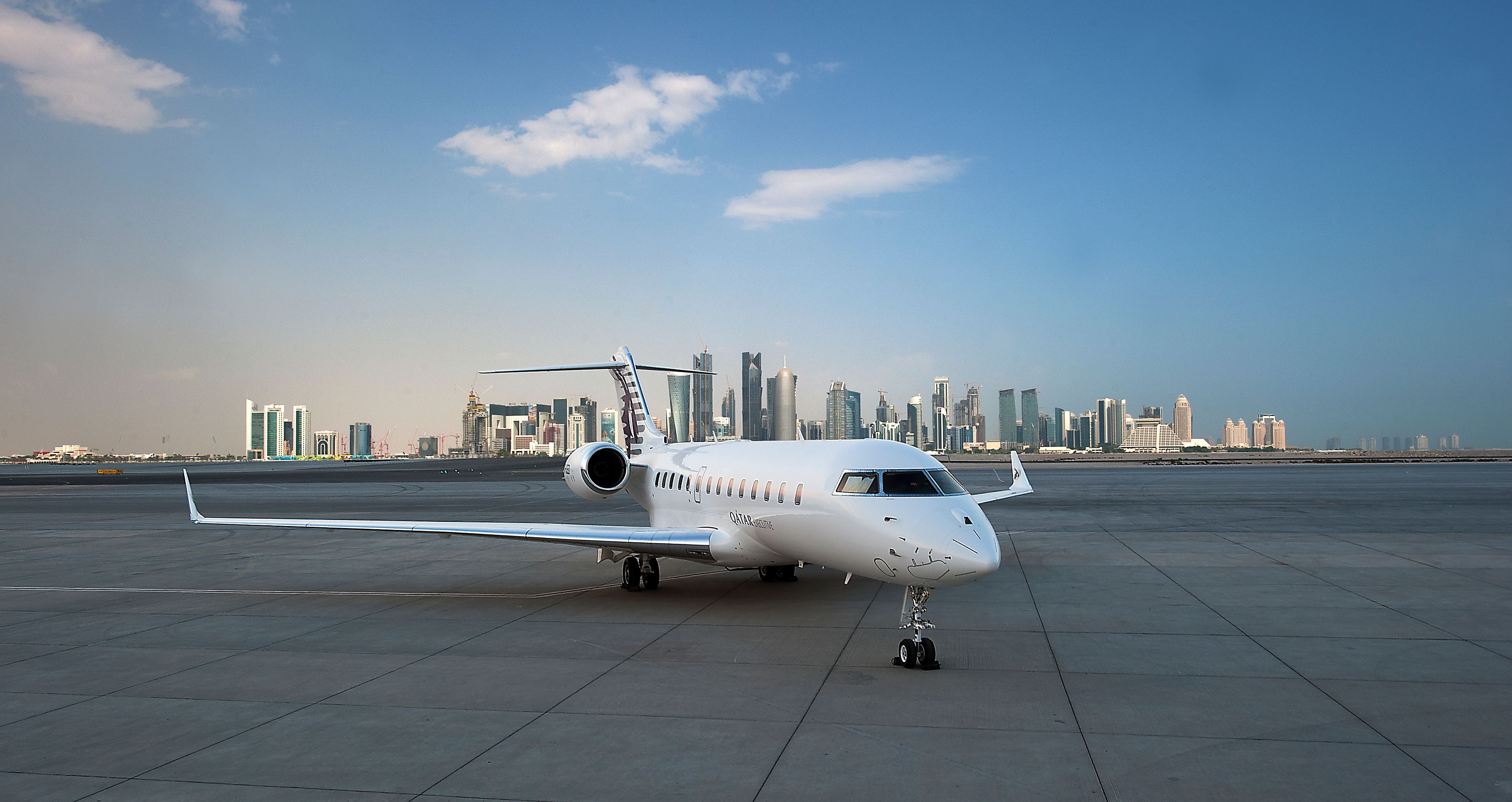 Qatar Executive's Bombardier Global 5000 Vision parked at an airport.