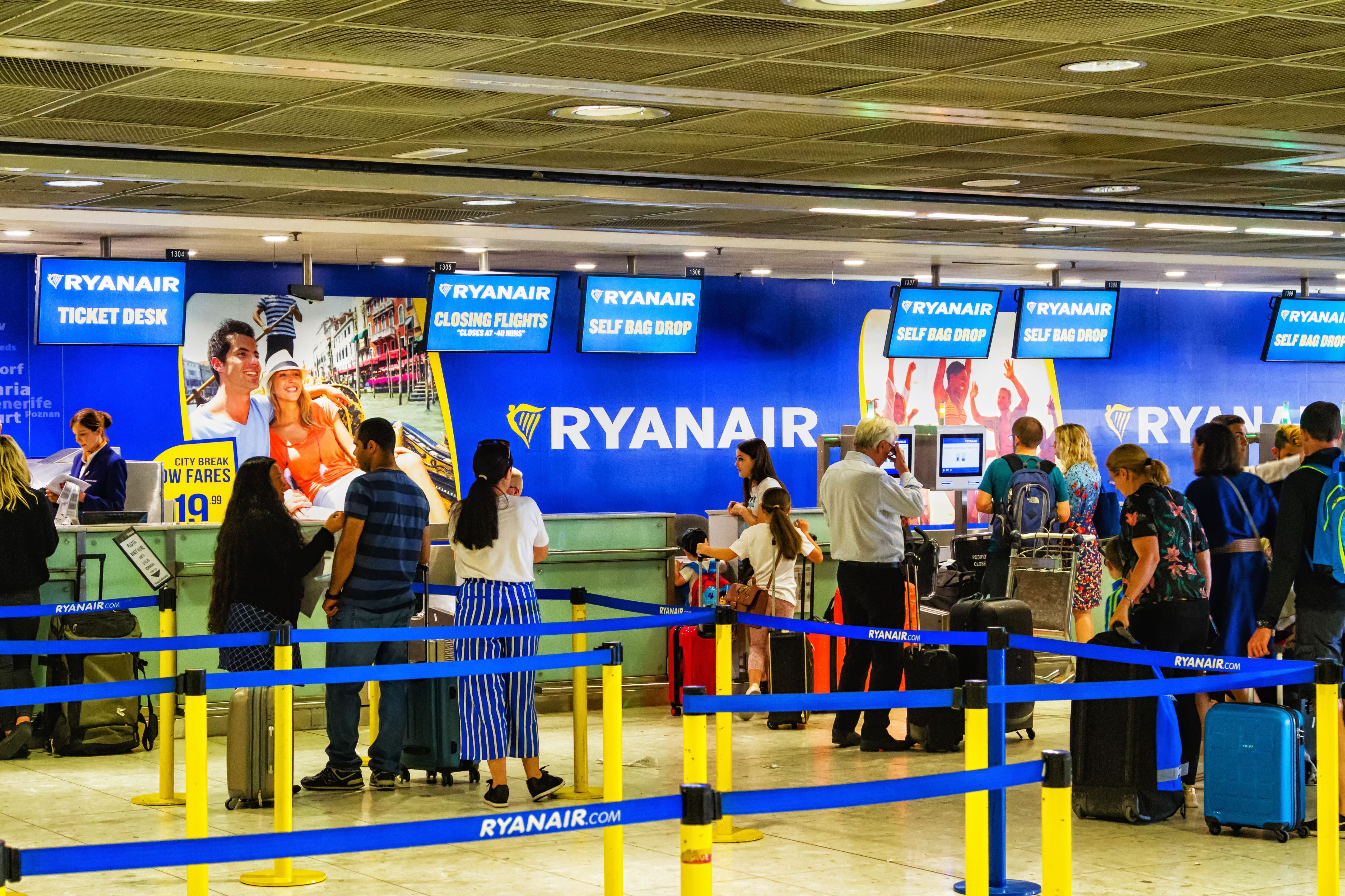 Passengers waiting to check in at Ryanair's check-in desks at Dublin Airport.